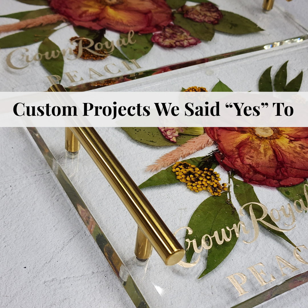 Two epoxy resin serving trays with the Crown Royal Peach Logo for a corporate branded gift from the marketing team of Crown Royal