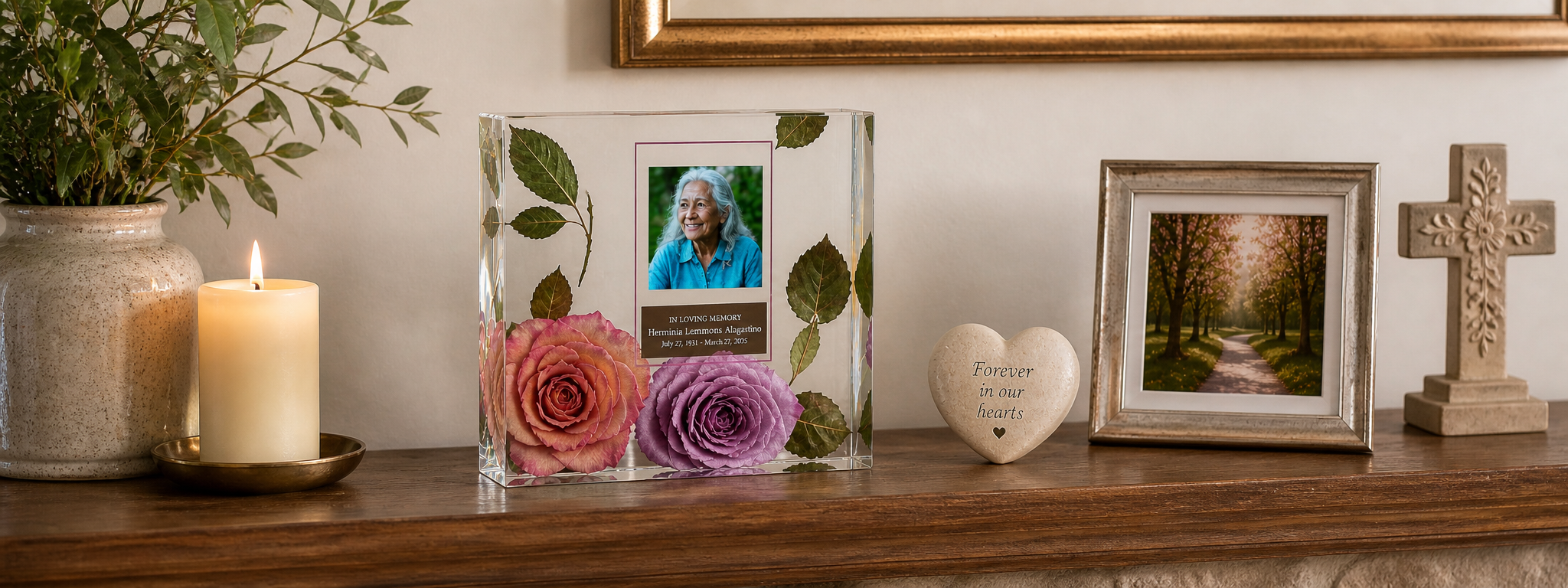 Decorative shelf with a candle, flowers, memorial framed photos, and a cross.