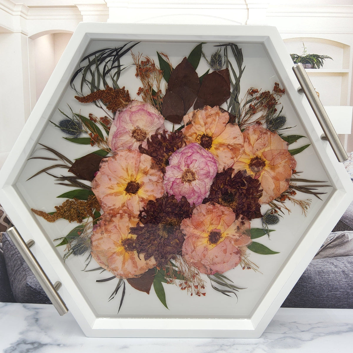 wedding bouquet pressed flower preservation white wood hexagon ottoman tray with silver handles and dried pink and orange roses and dahlia