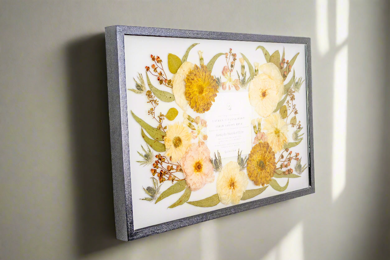 Pressed flower framing for bouquet preservation with invitation resin framing