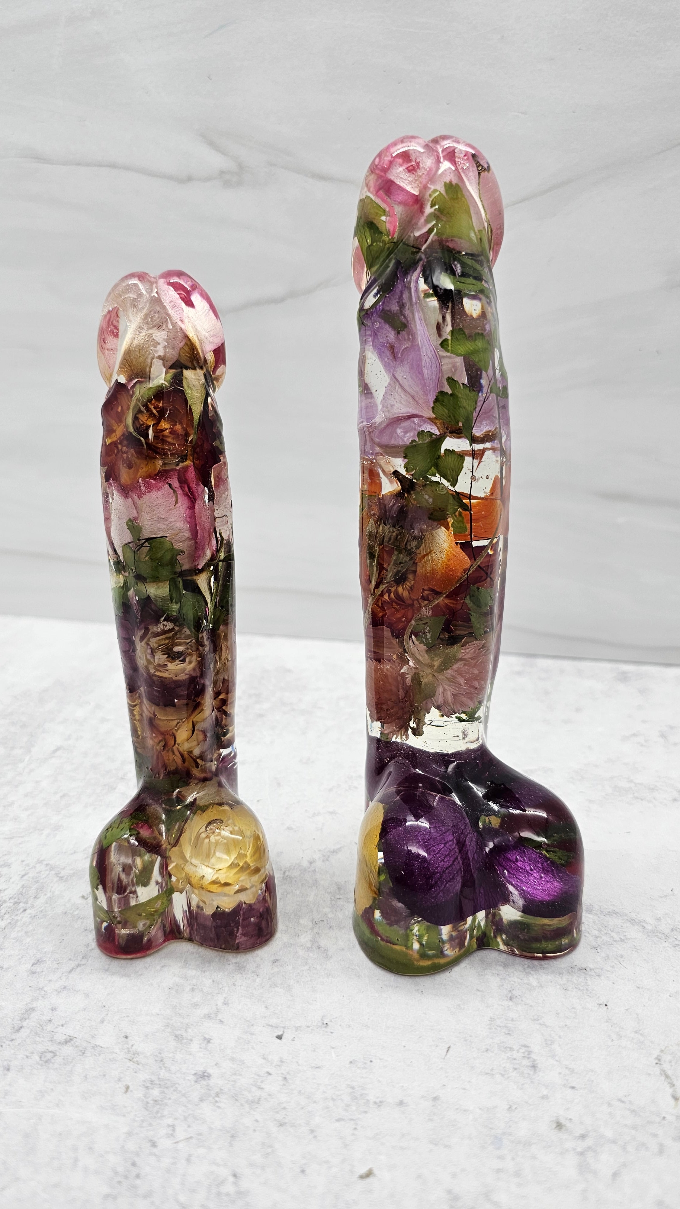 Resin peen dildos shown in two different sizes