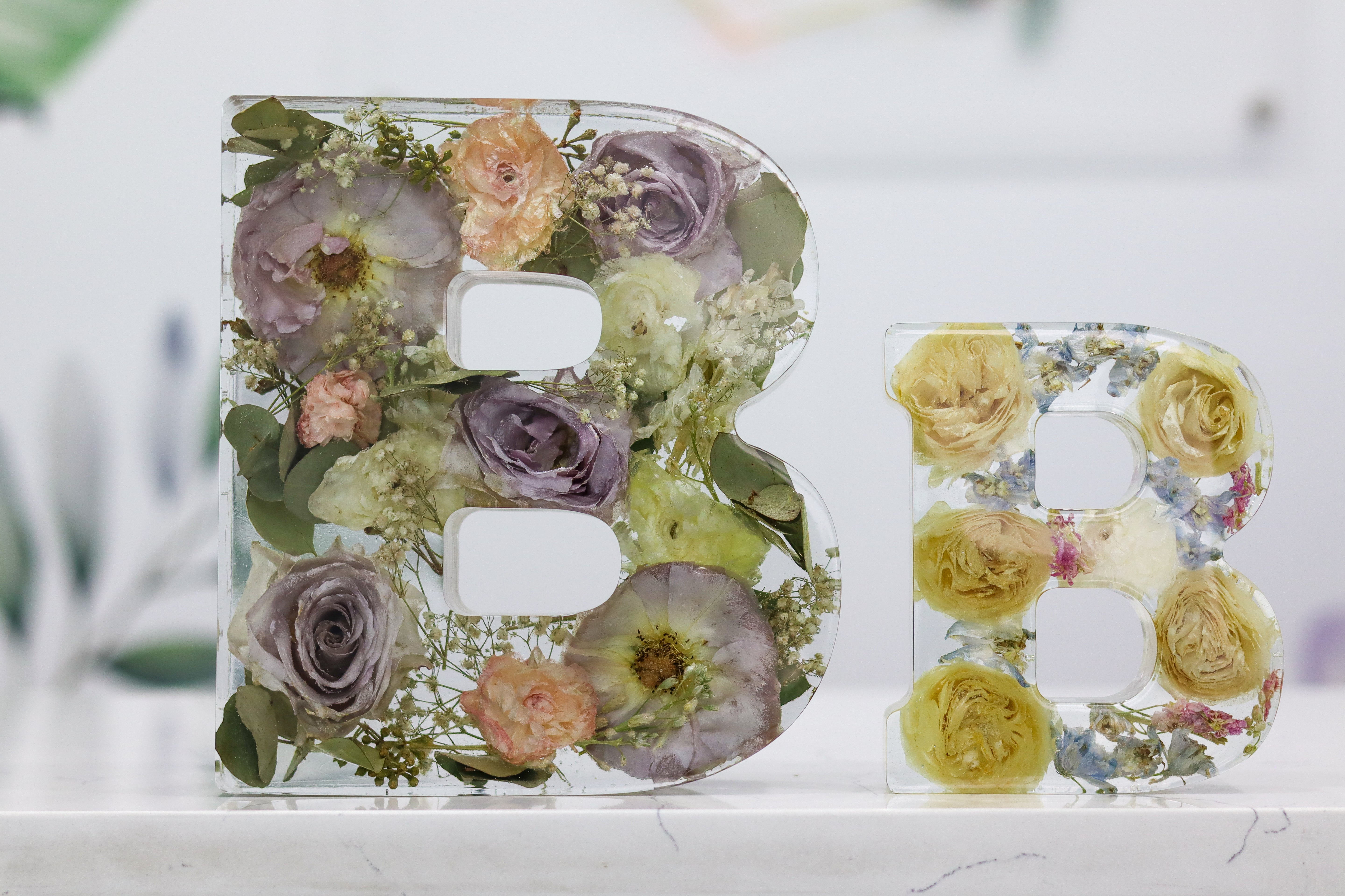 Resin Letter Shape 'B' flower preservation blocks on display to show size difference