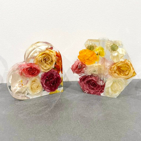 Tall portrait photo of a pressed flower heart resin block with mixed dried bouquet flowers
