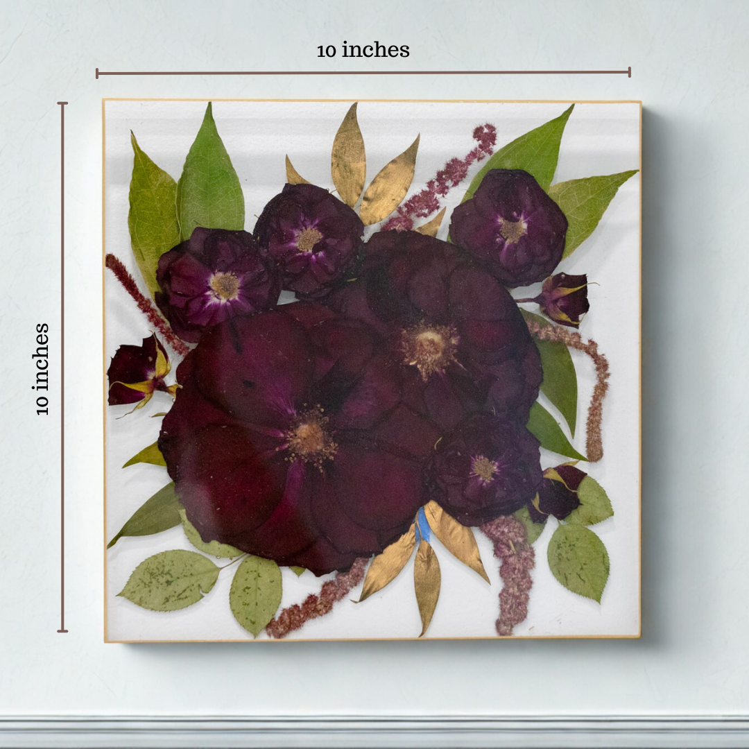 Square decorative piece with pressed flowers and leaves, measuring 10x10 inches.