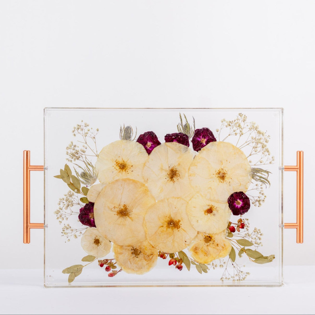 Decorative tray with pressed floral design and rose gold handles on a white background