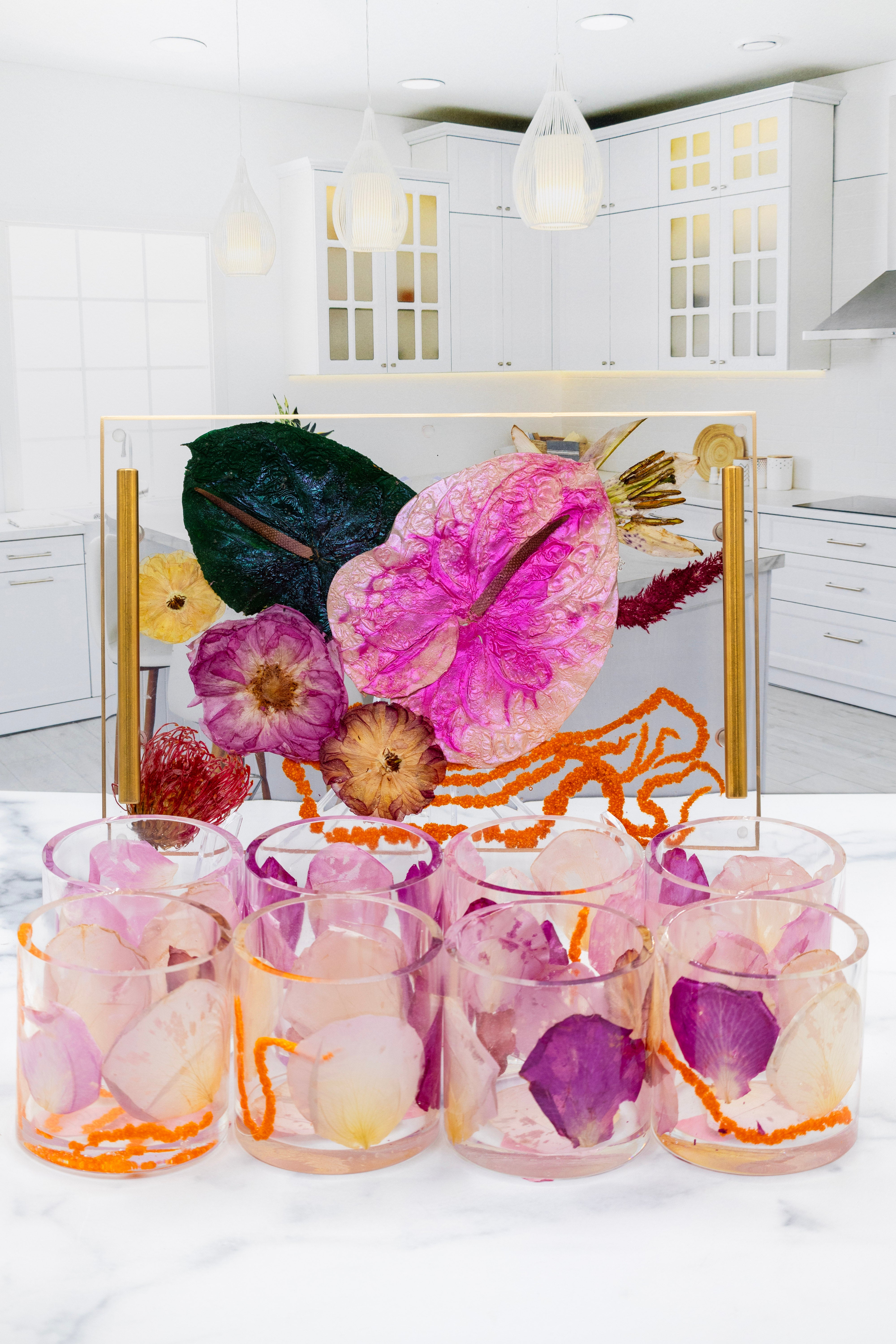 Decorative glass jars with floral design on a white surface