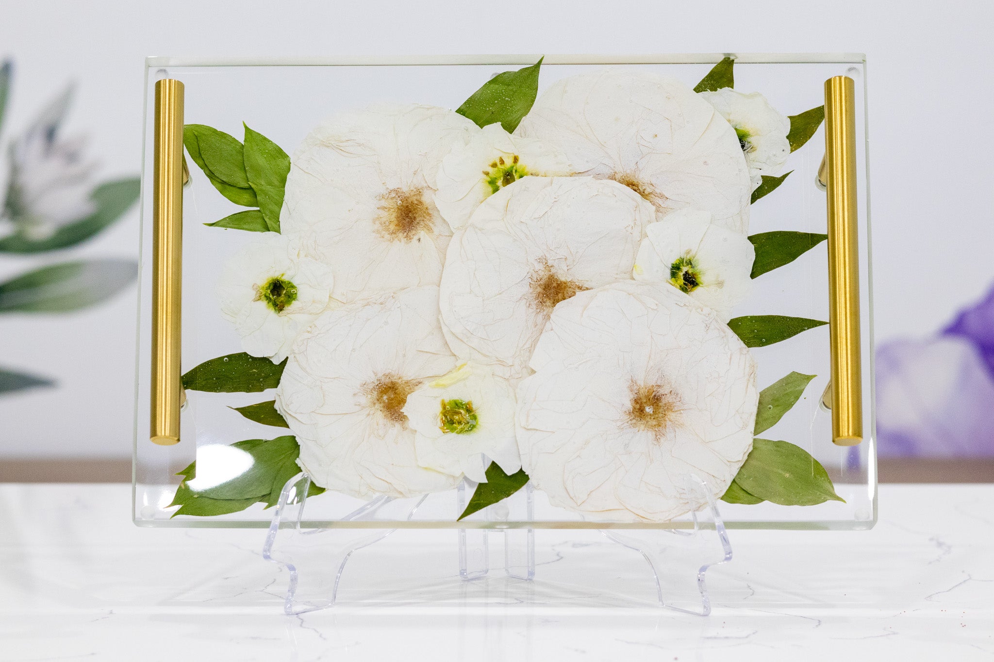 A rectangular pressed flower serving tray with color correction on white roses