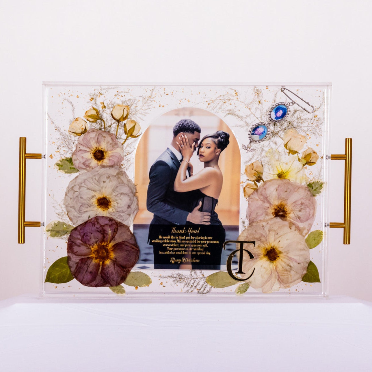 Wedding bouquet preservation with invitation and bouquet charm preserved in resin tray