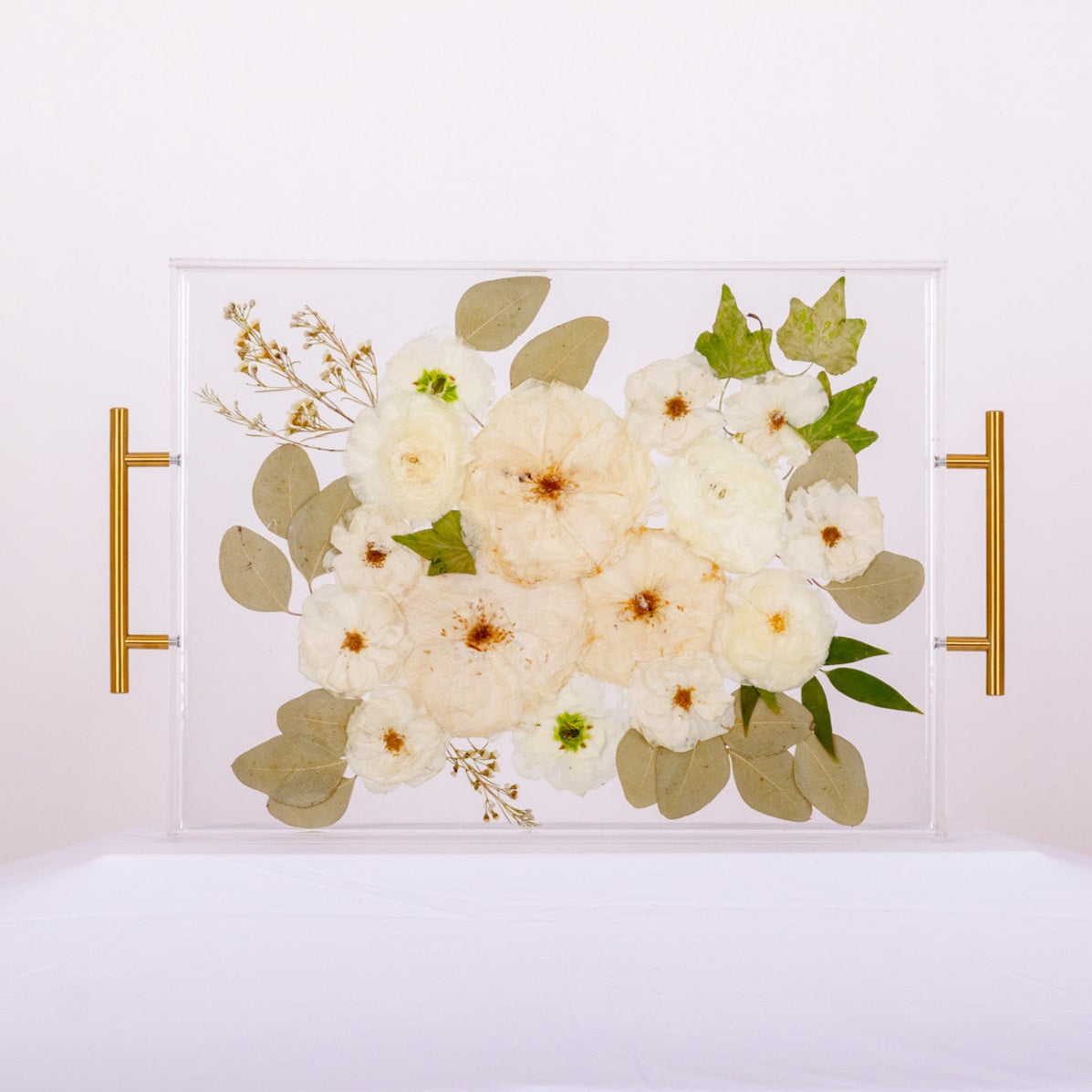 White rose and eucalyptus preservation in resin tray with gold side handles