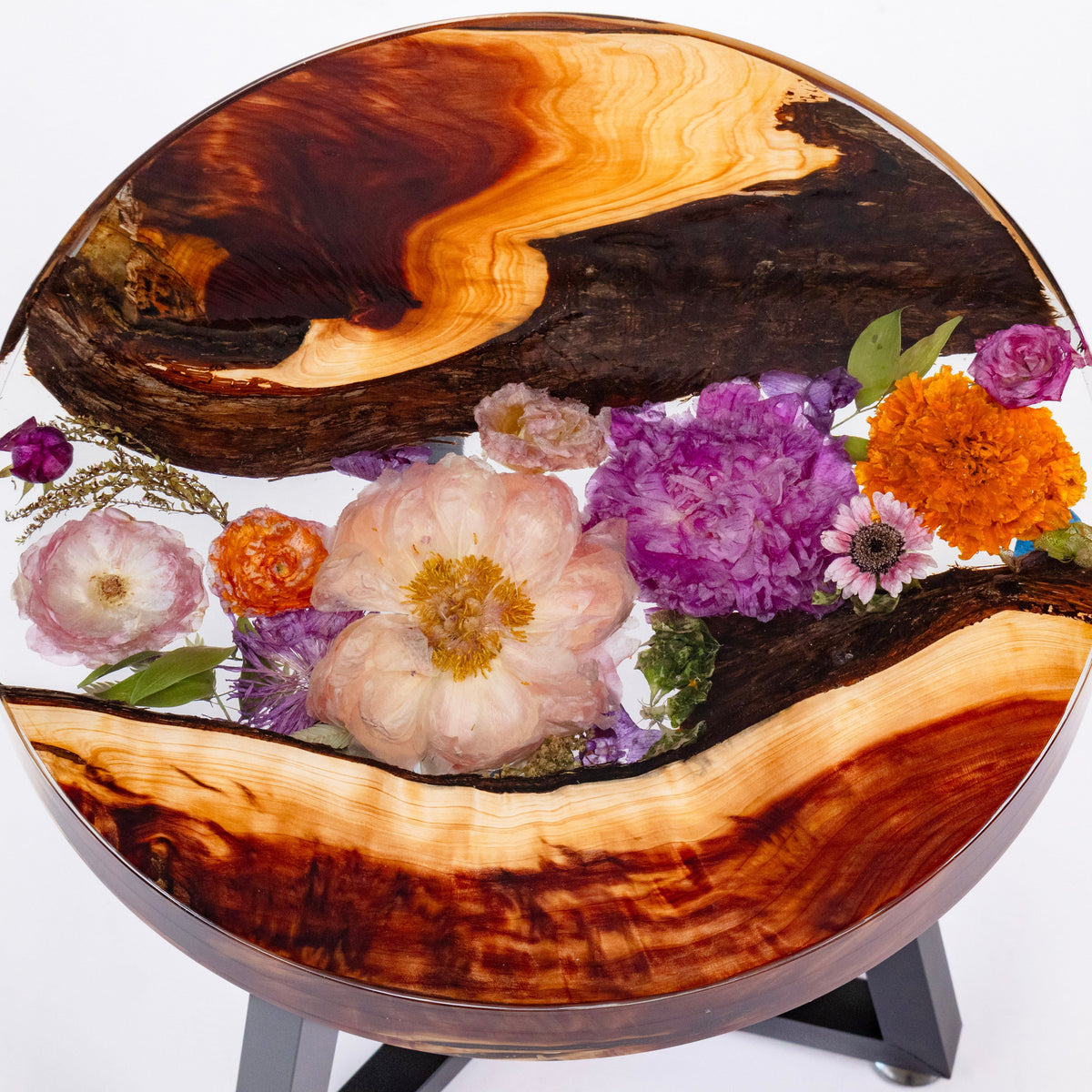 Wide landscape photo of an 18-inch live edge pressed flower side table with mixed dried blooms