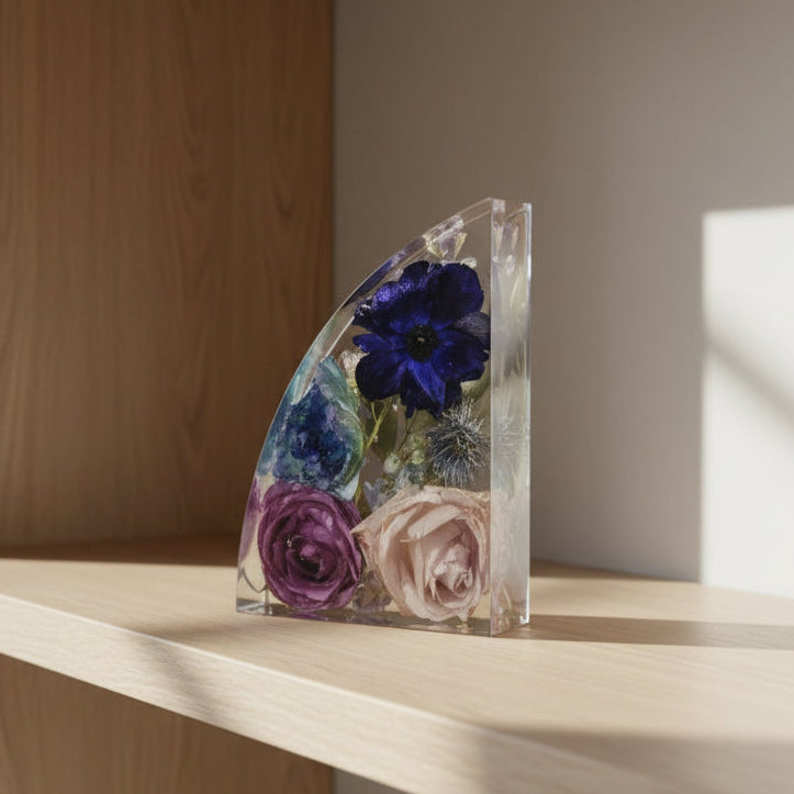 Bookend on bookshelf with resin preserved bouquet blue and purple flower preservation