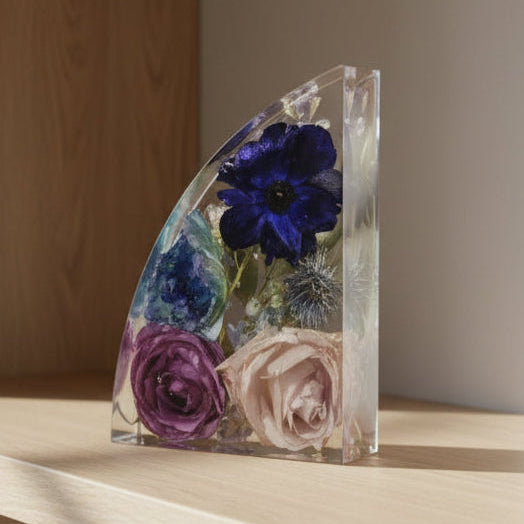 Bookend on bookshelf with resin preserved bouquet blue and purple flower preservation