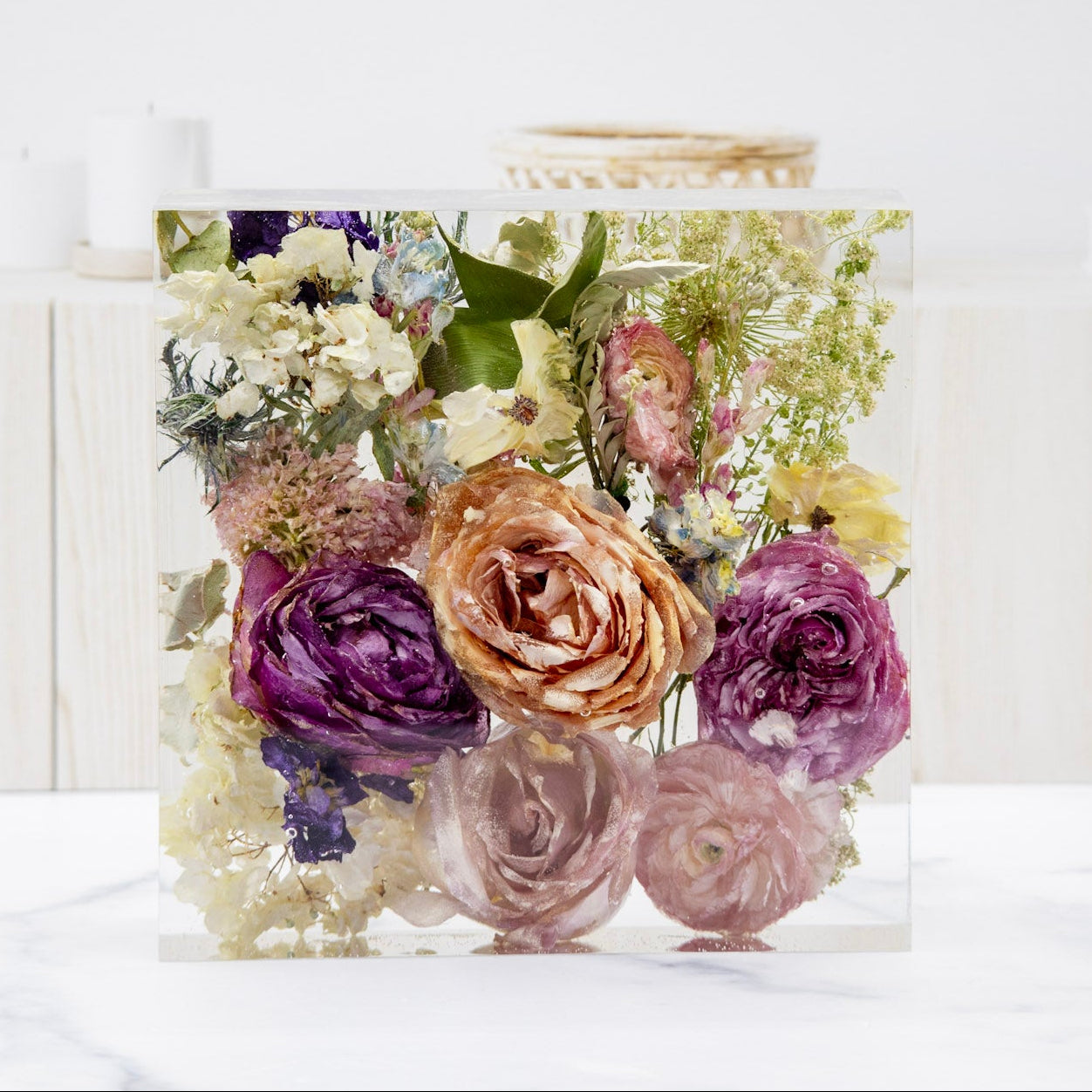 whole flower preservation resin block of dried wedding bouquet flowers on a white surface