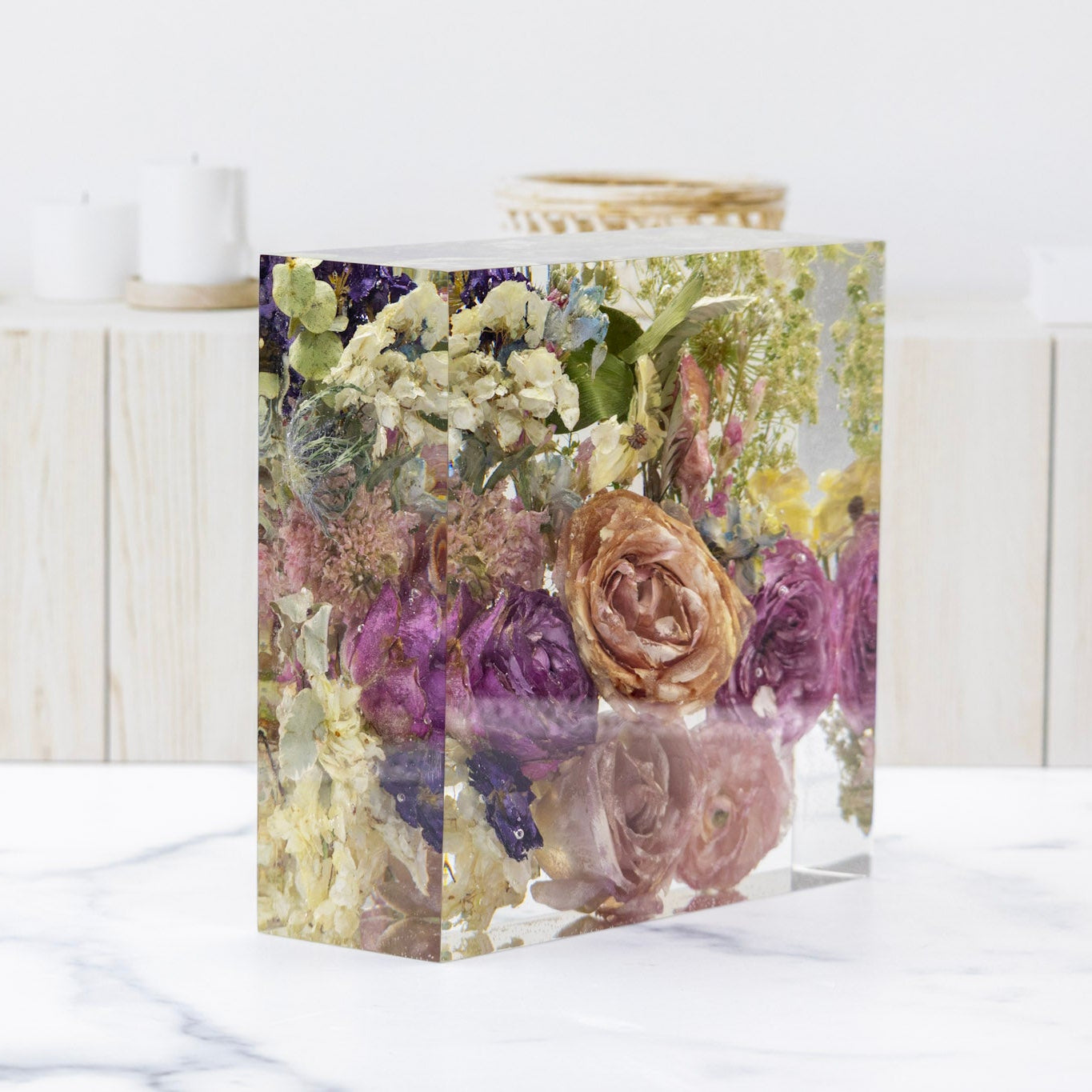 Flower Preservation Resin Block on a white surface with a light wooden background