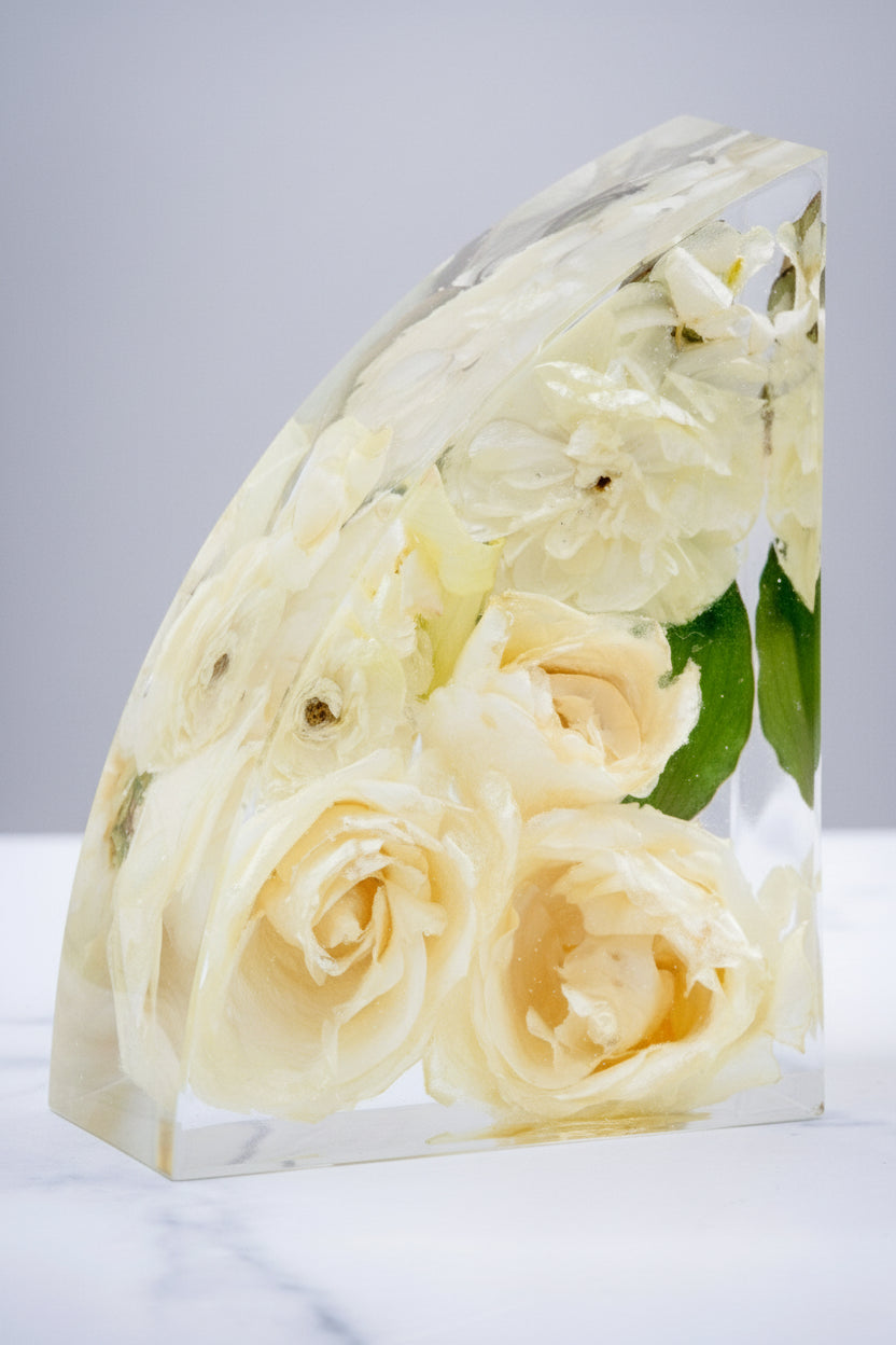 Bookend on marble countertop with resin encased flower preservation bouquet keepsake White flowers