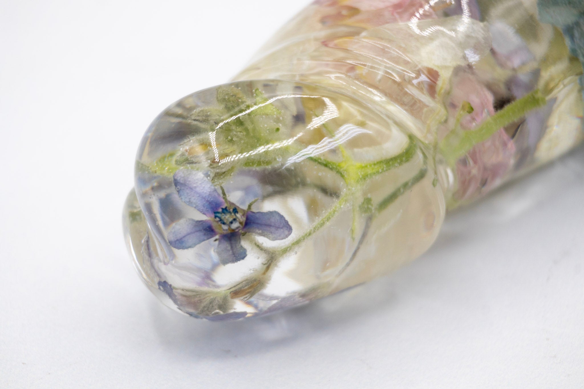 Clear resin dildo with preserved flowers inside.