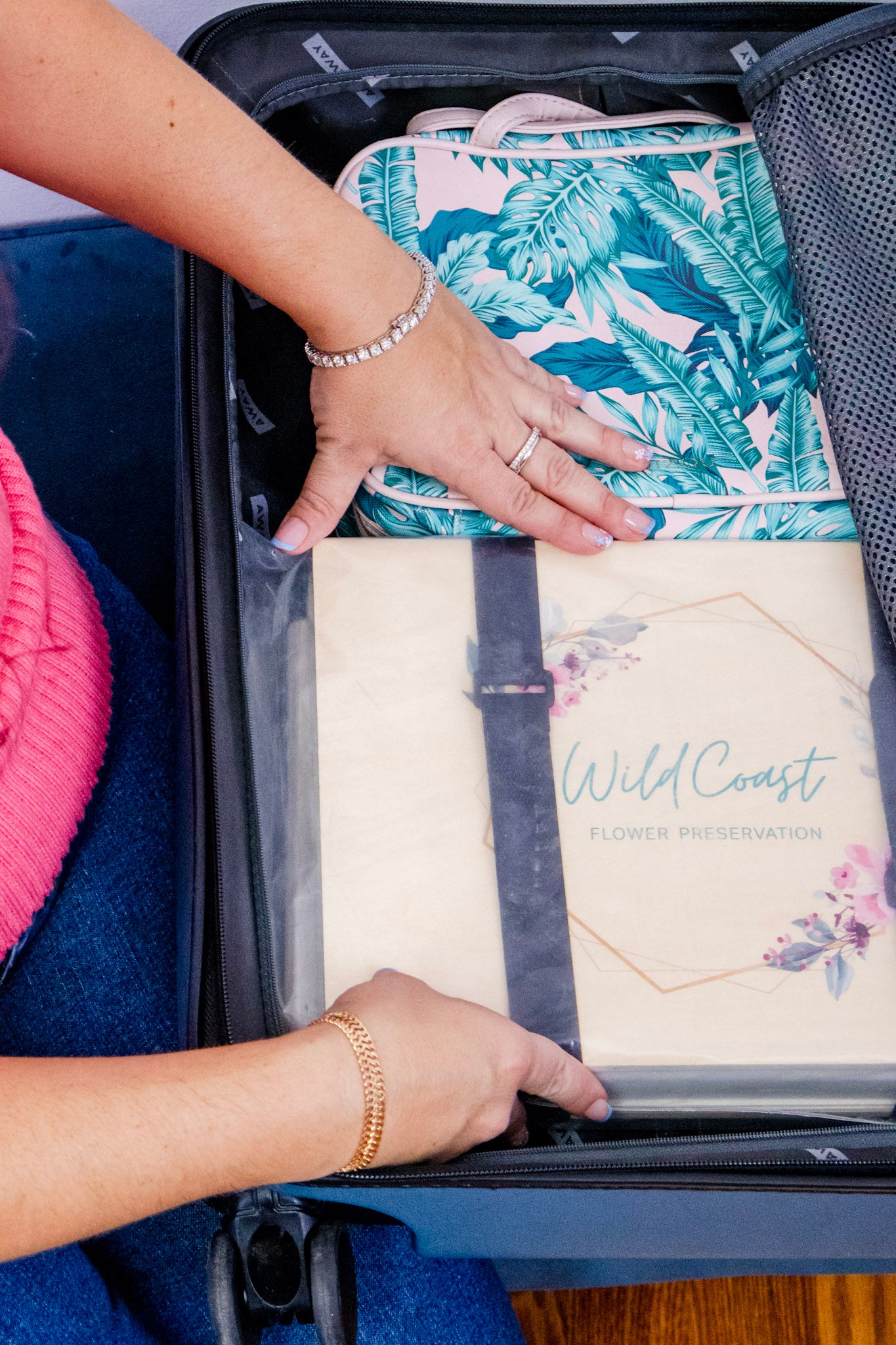 Person packing a wedding flower press for travel
preserve bouquet destination wedding into a suitcase