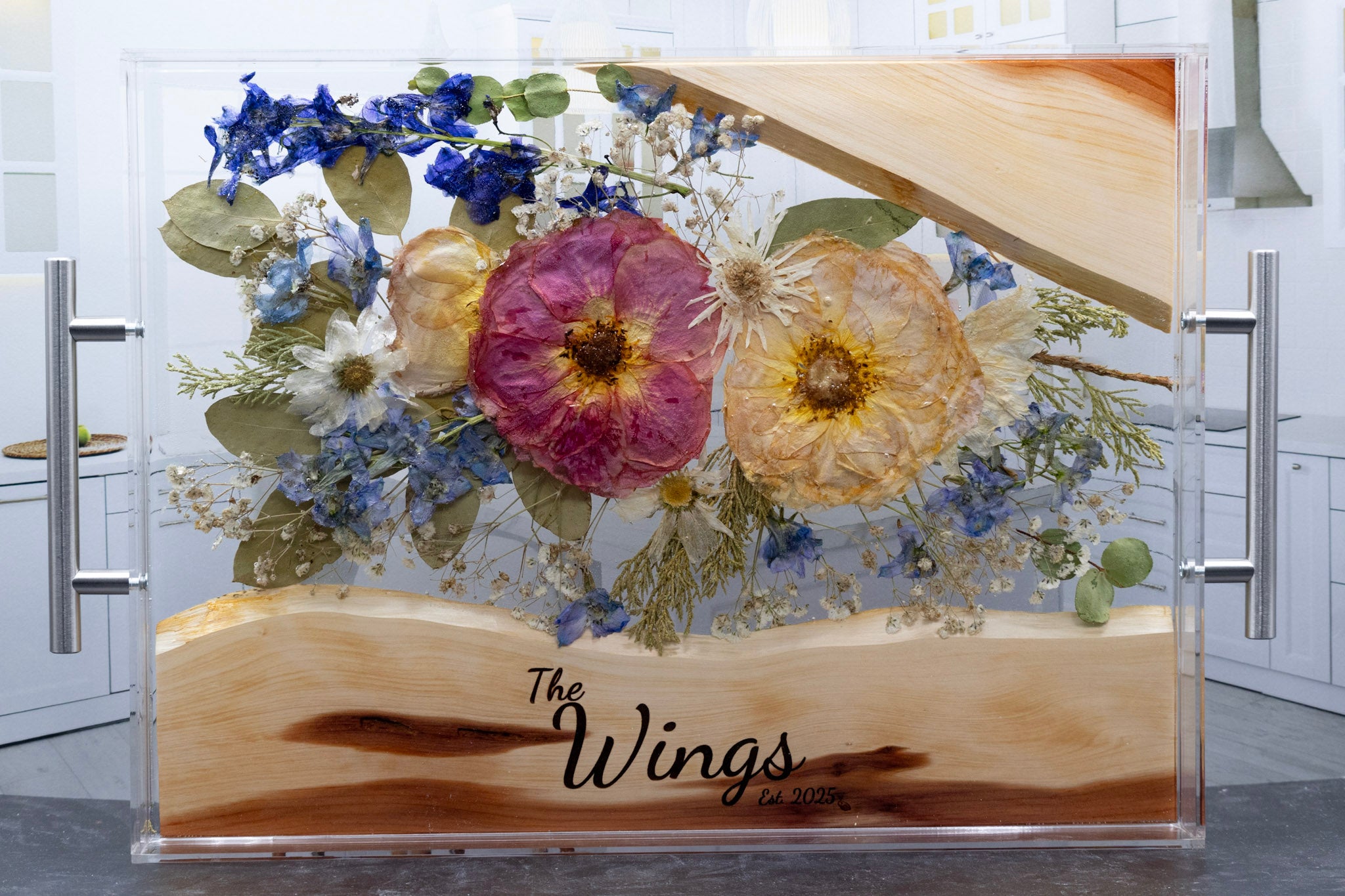 Pressed wedding flowers preserved in epoxy resin and acrylic serving tray with live edge wood and custom engraving that says The Wings in Font C