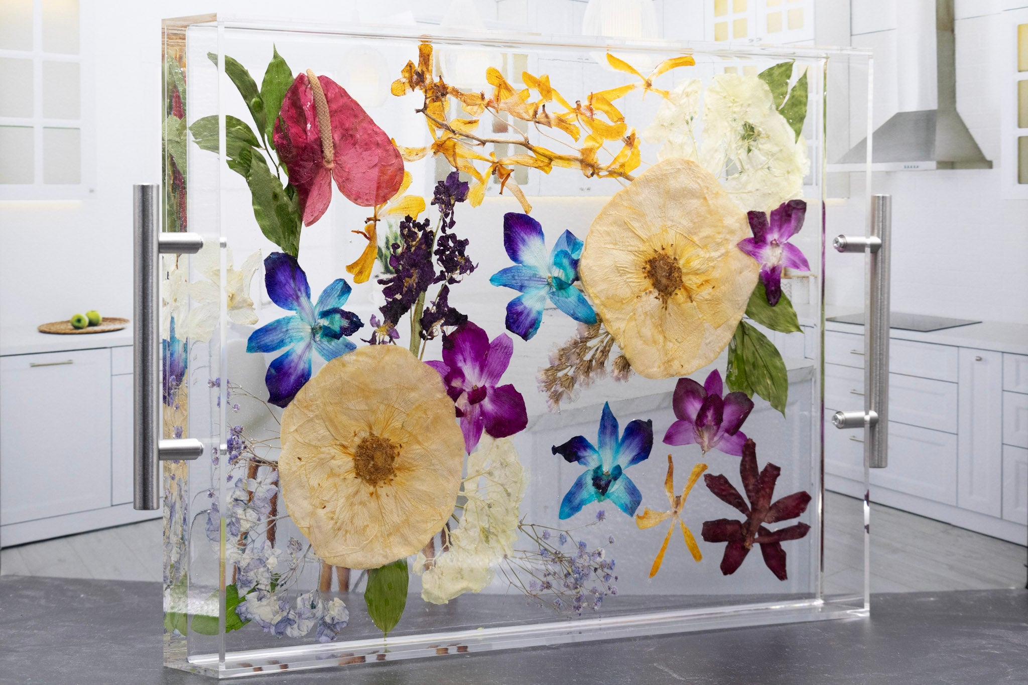 Pressed flower tray with lip around the edge and silver handles for serving food or drinks in the kitchen