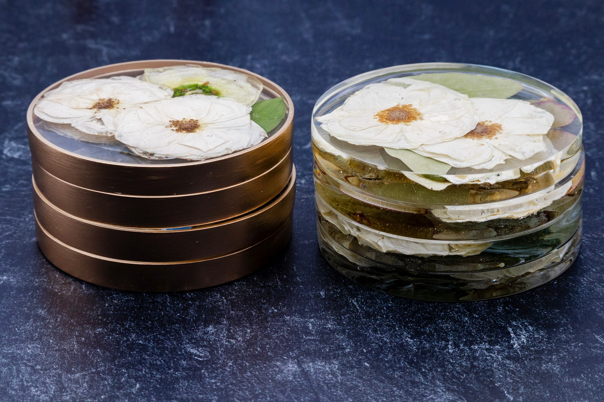 Stack of round coasters with floral design on a dark surface