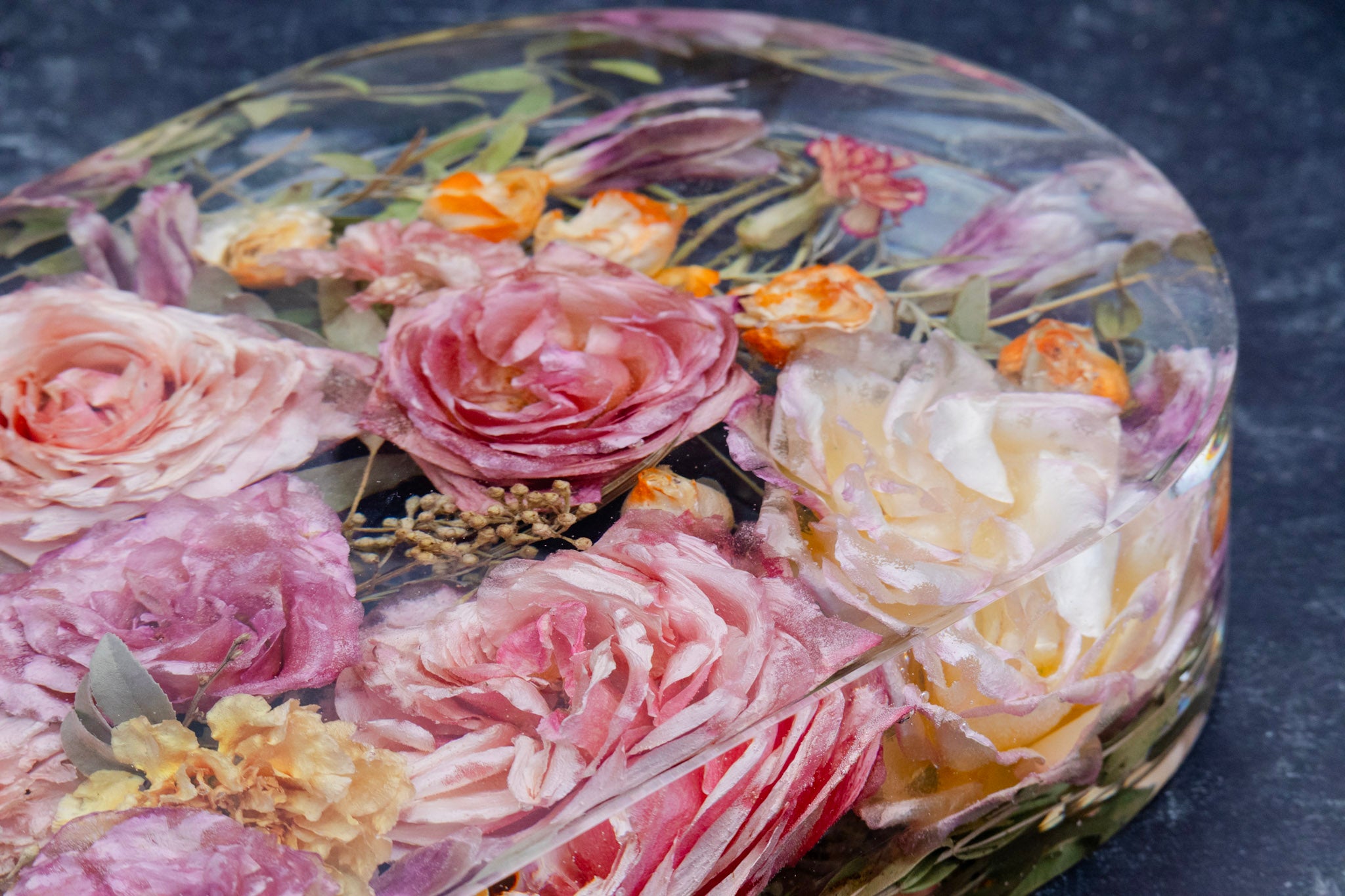 Dried flowers in resin on a dark background