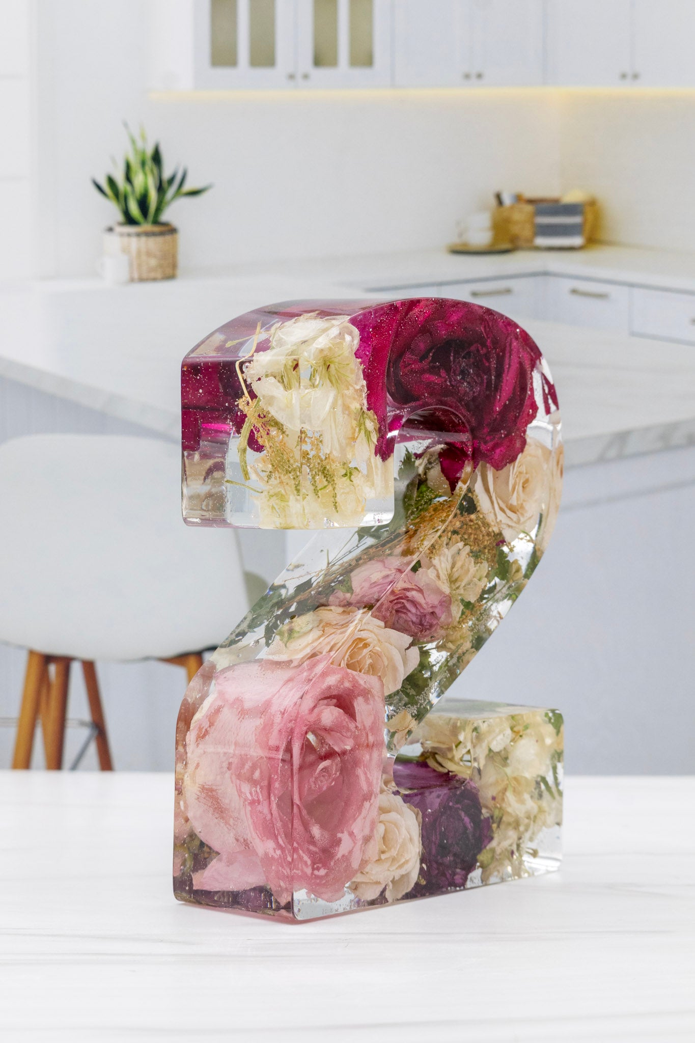 Resin Bouquet Preservation Number 2 at an angle to see the dried flowers inside on a kitchen counter