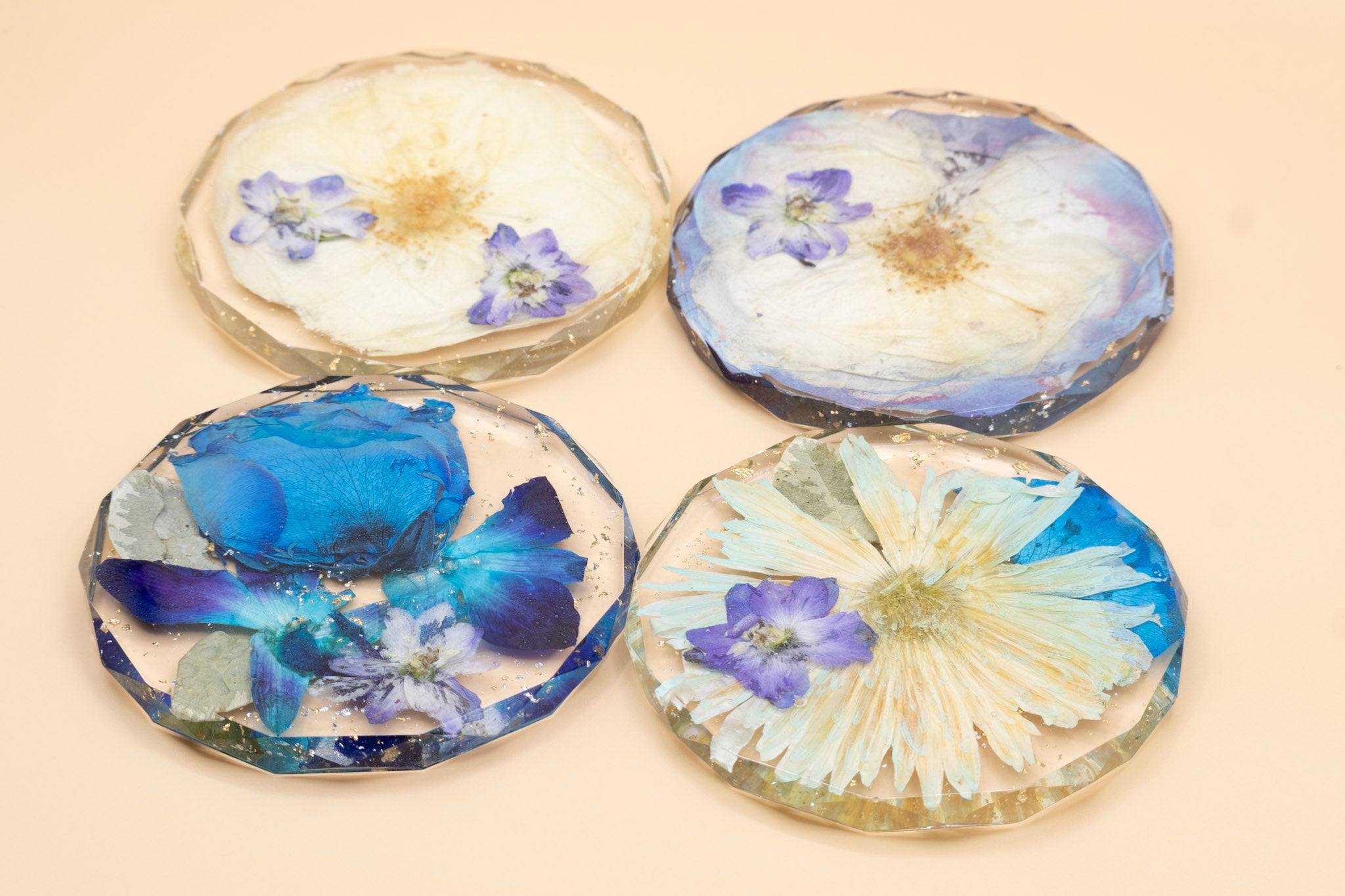 Funeral Flower Preservation Diamond Edge Coaster with Blue Flowers on a beige background