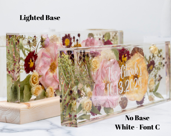 Floral design with 'The Clarks 10.3.2029' text on a lighted base and white background.