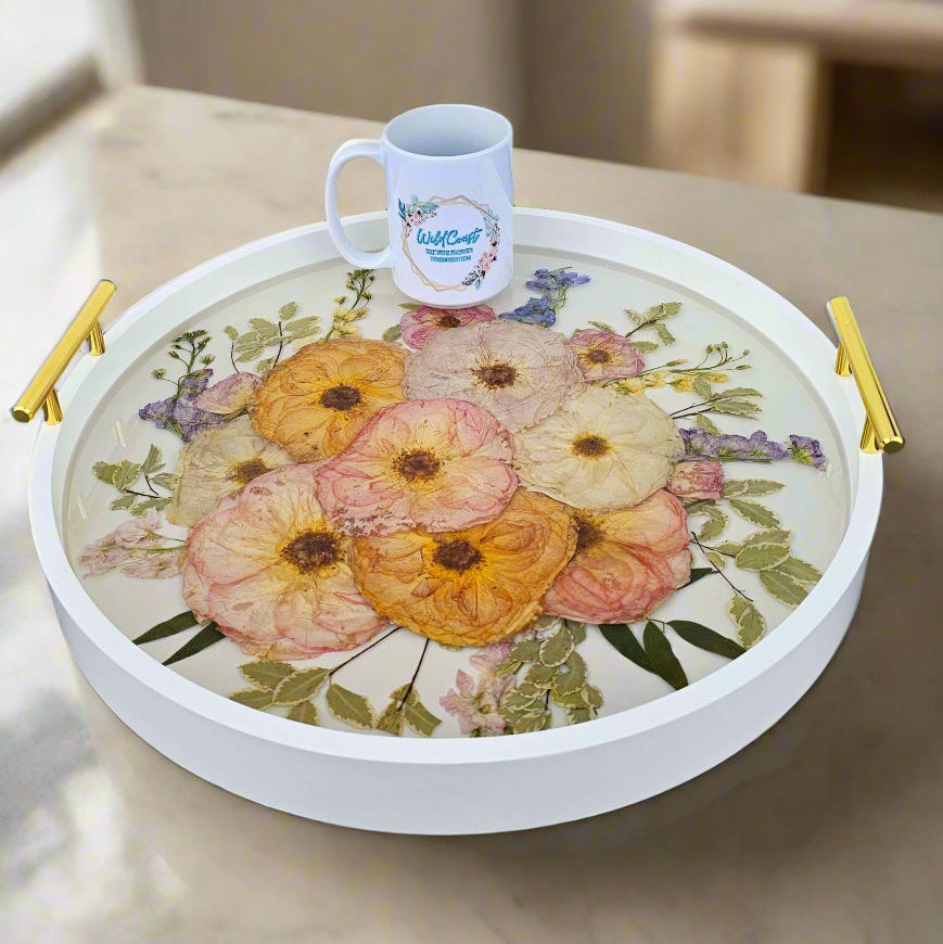 White round wood tray with gold handles and resin Bouquet Preservation inside showing clear resin and pressed roses
