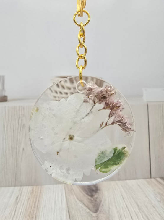 Round keychain with dried flowers and leaves on a light wooden surface. Wedding Bouquet Preservation Keychain Round Pressed Flower Keychain Flower Preservation Custom Keychain Preserved Bouquet Keychain