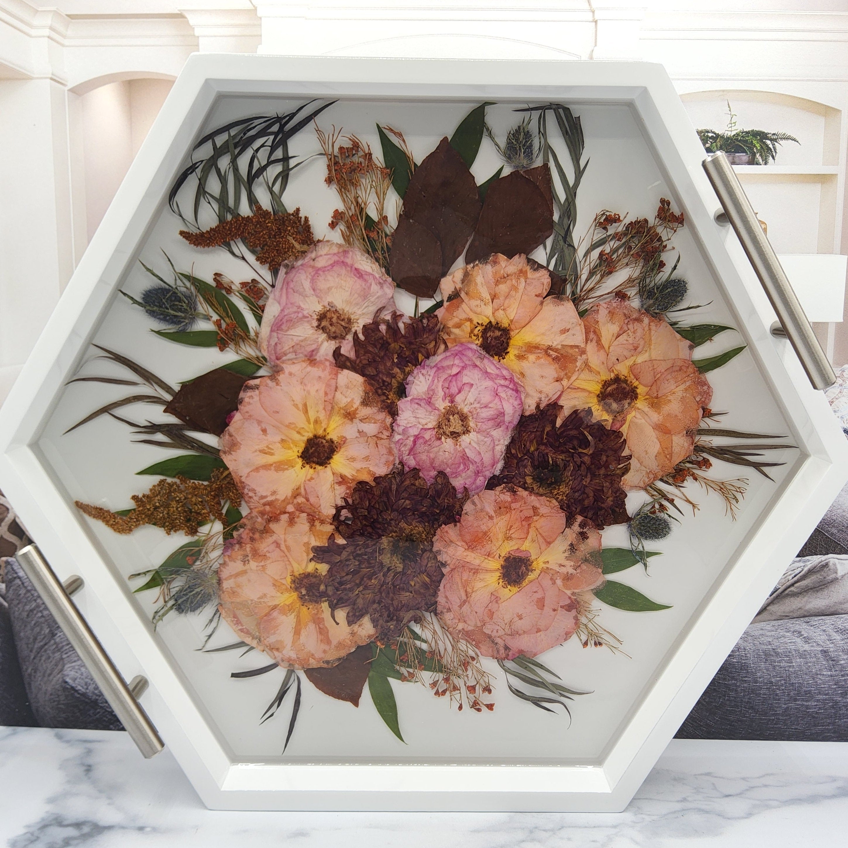 wedding bouquet pressed flower preservation white wood hexagon ottoman tray with silver handles and dried pink and orange roses and dahlia