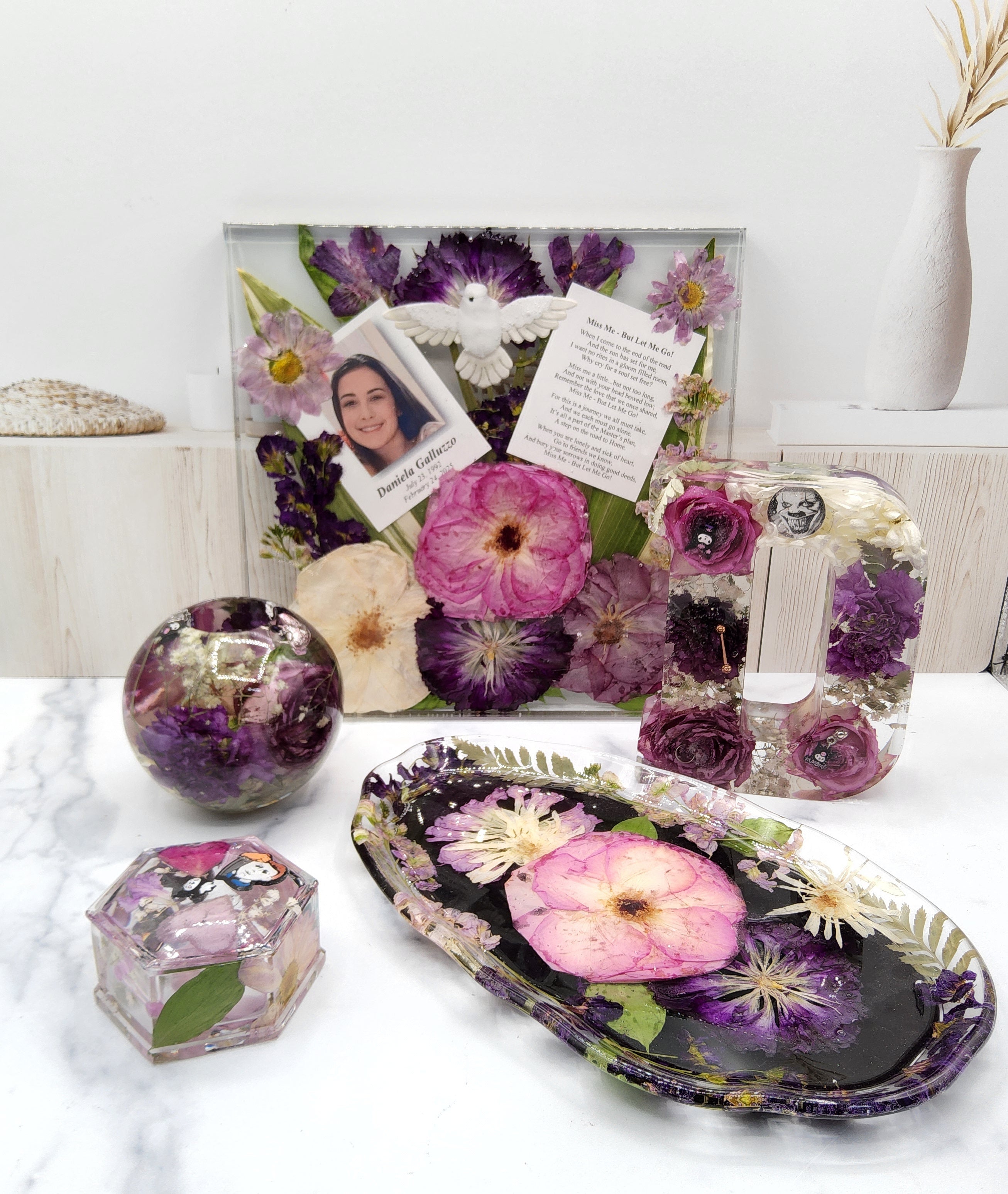 Decorative items with pressed flowers on a white surface