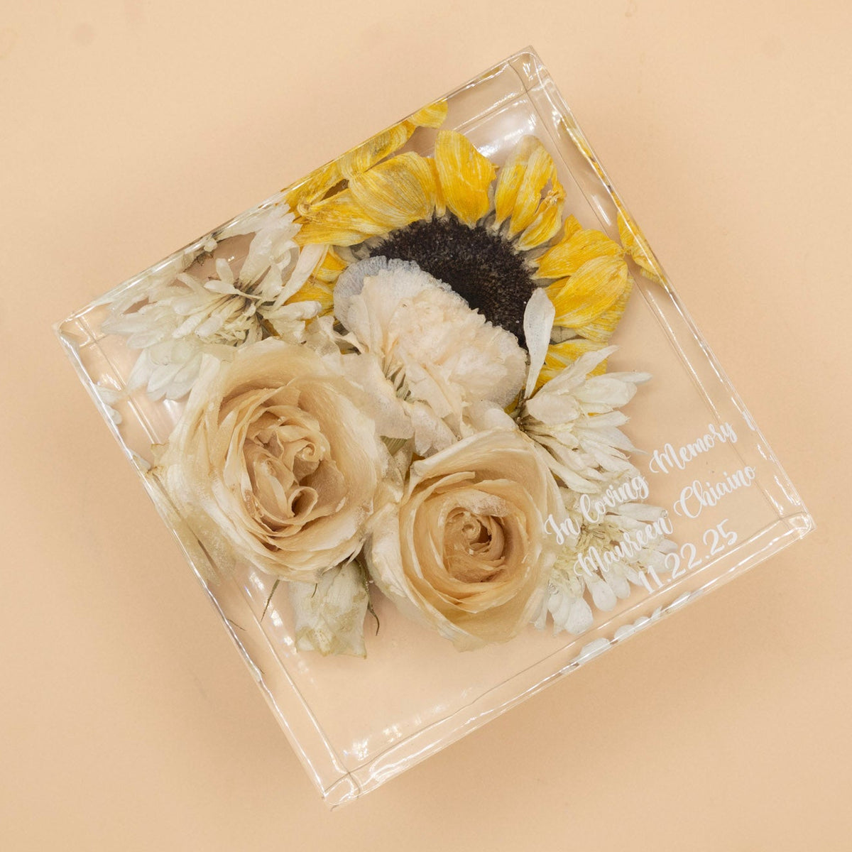 square preserved flower resin block featuring sunflowers and white roses with memorial inscription in the corner on a beige background