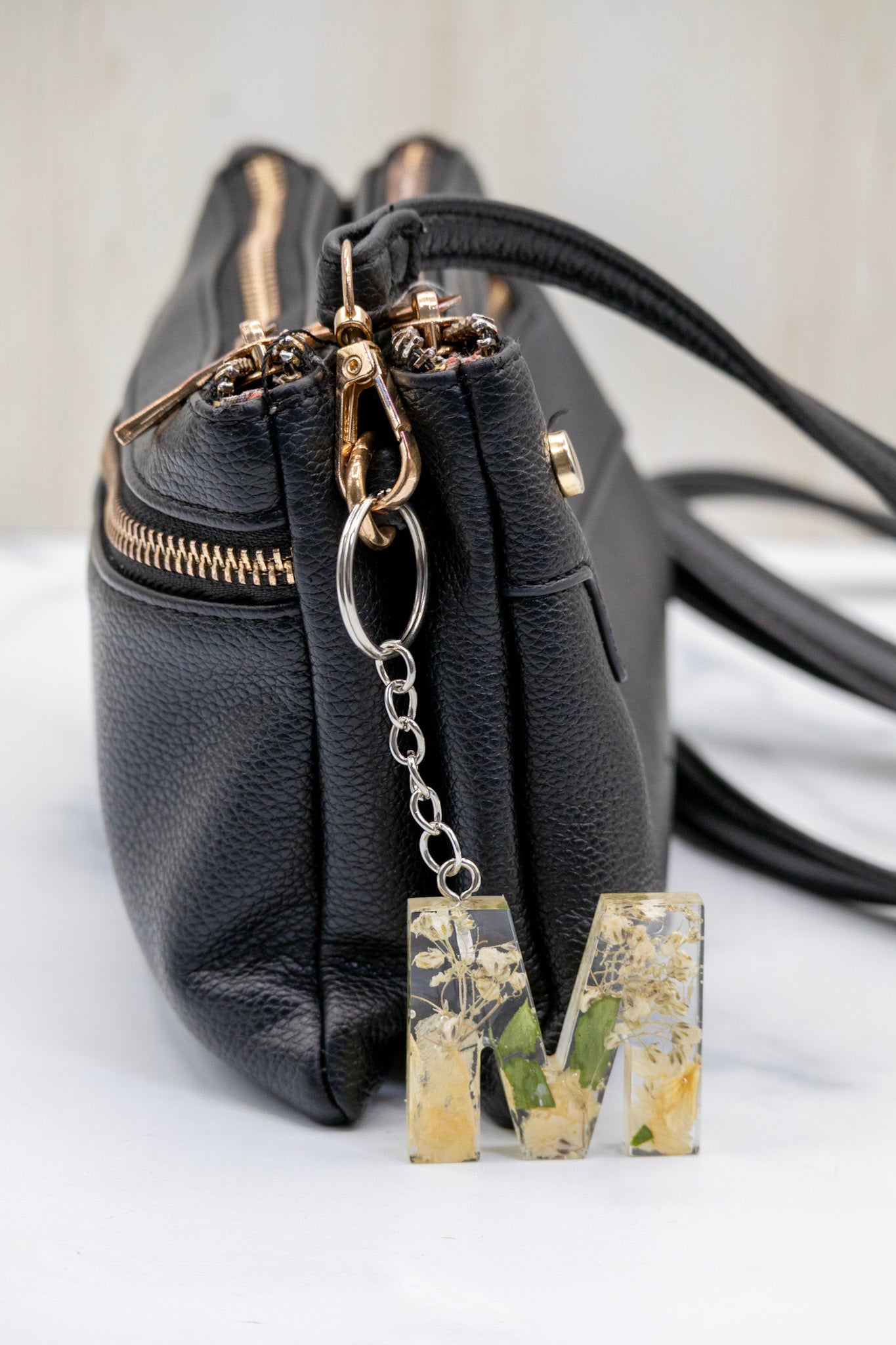 Bouquet preservation monogram key chain featuring dried flowers in transparent letter resin