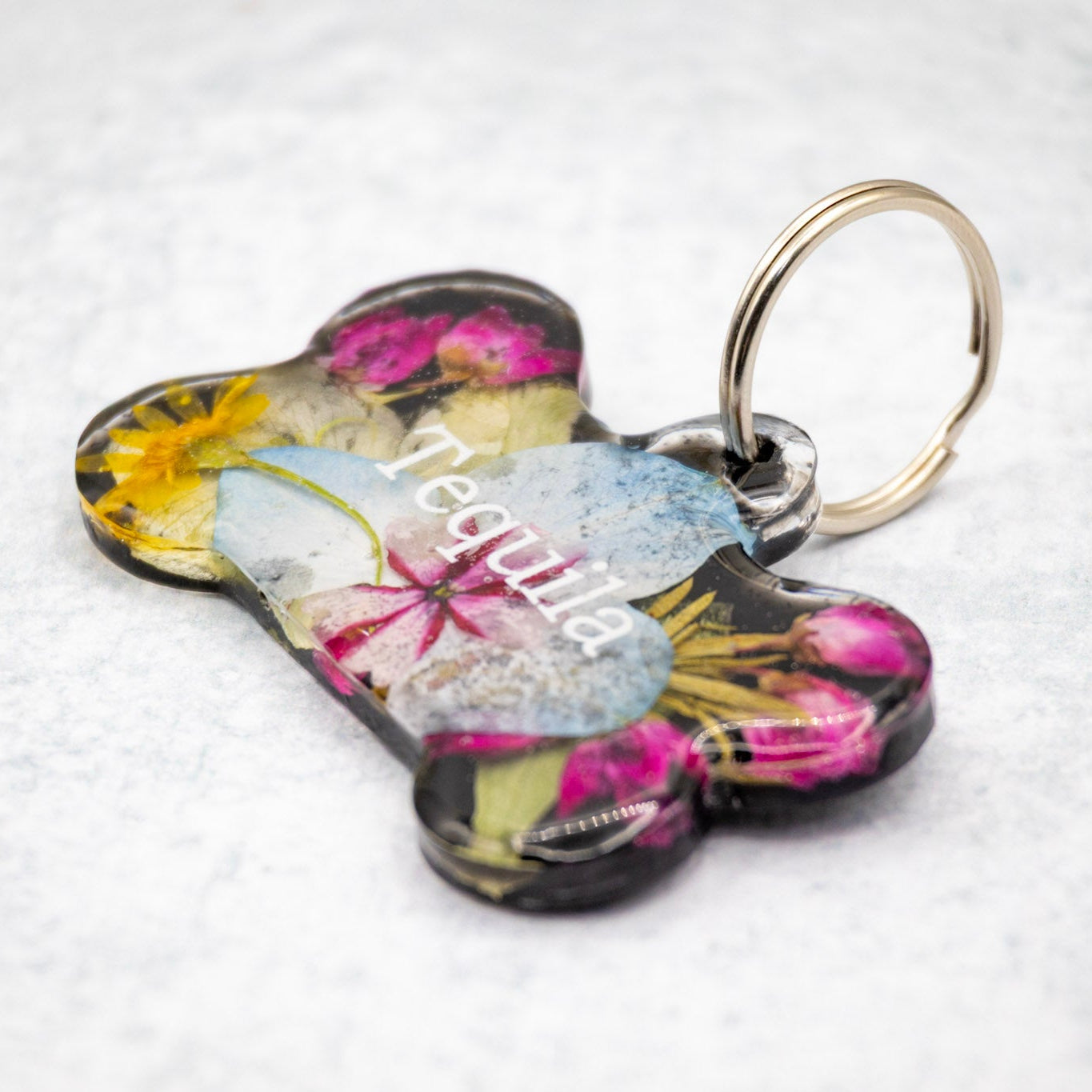 Landscape photo of a pressed flower resin bookend set with vibrant mixed dried flowers on a dark surface