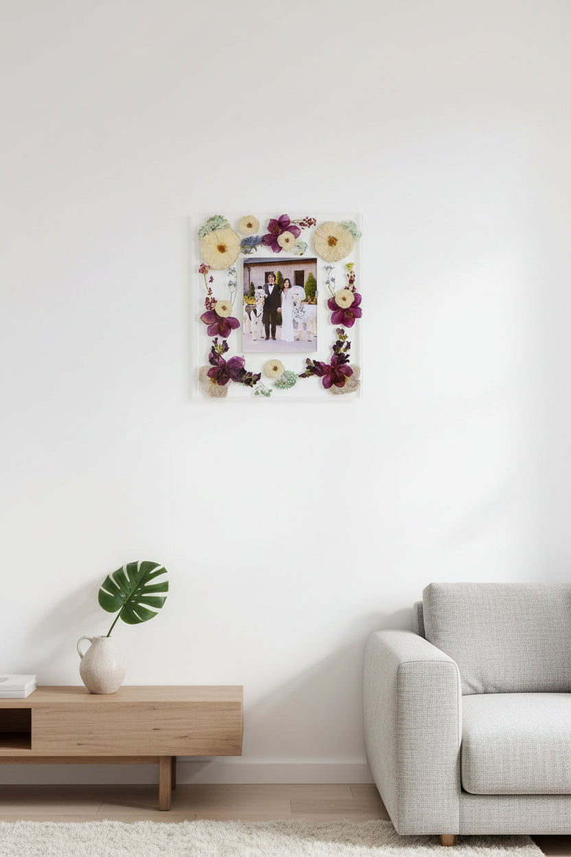 Decorative resin photo frame with pressed flowers and a family photo of a couple and their lamas. Epoxy resin frame.
