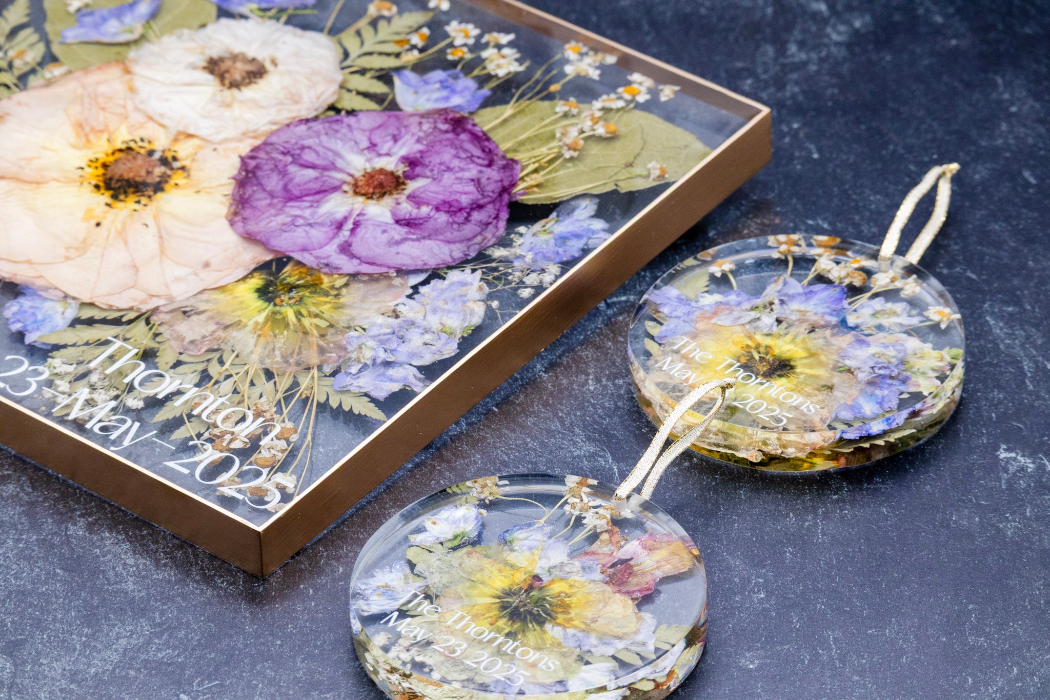Decorative coasters with floral designs on a dark surface
