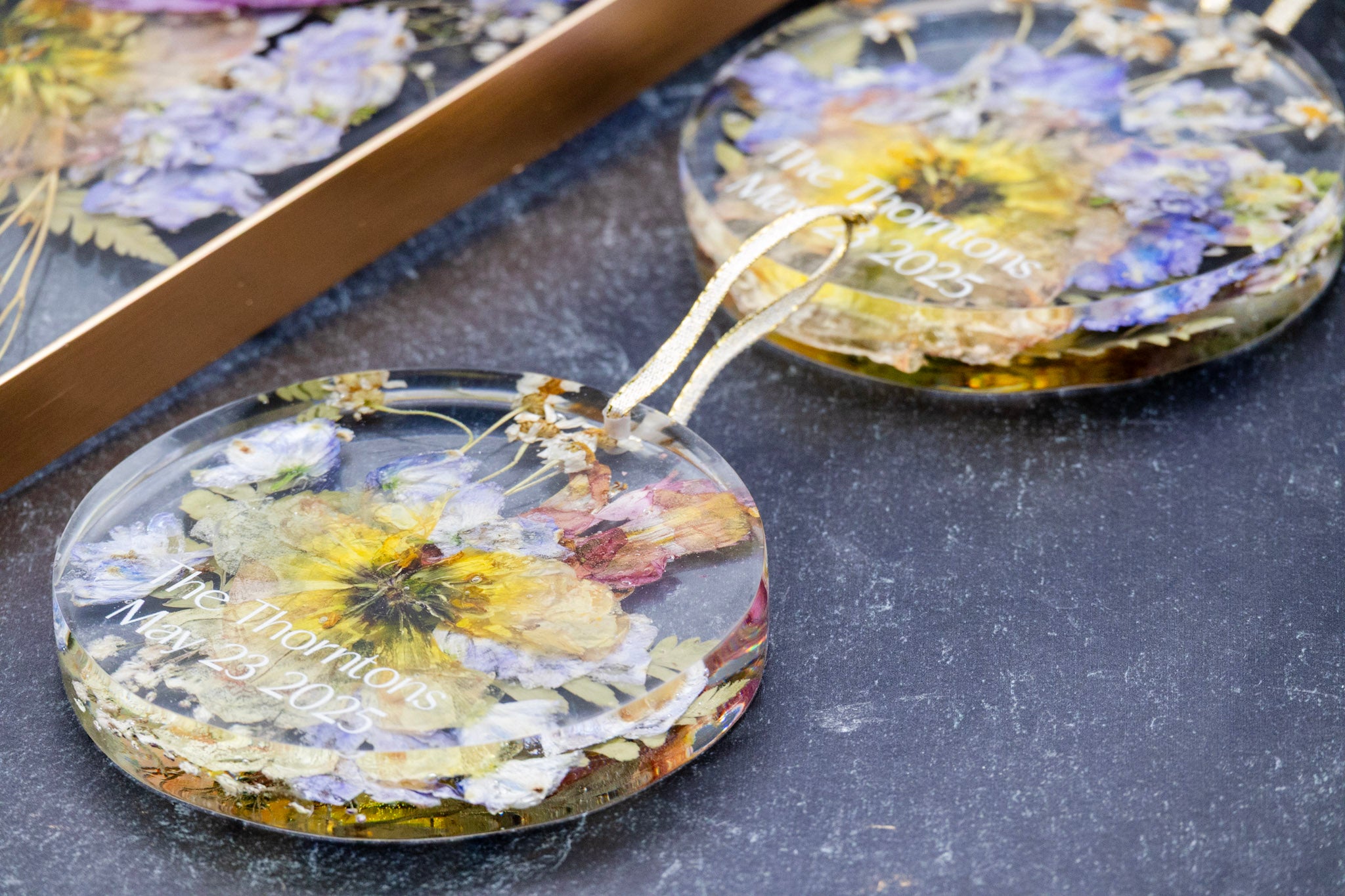 Decorative items with pressed flowers on a dark surface