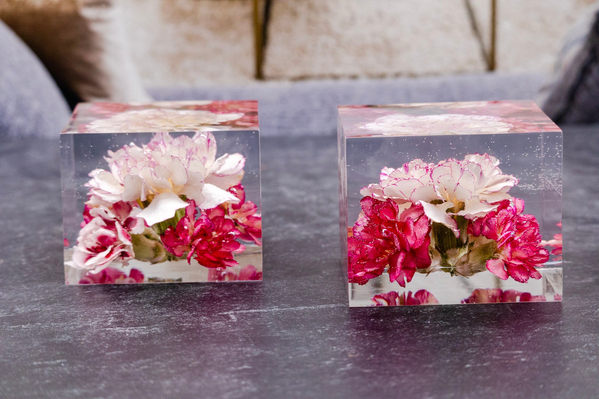 corsage preservation dried flower boutonniere Two clear acrylic blocks with floral designs on a dark surface.
