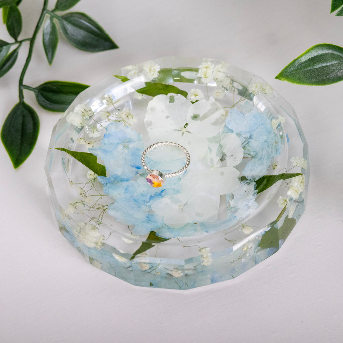 preserved white and blue hydrangea in round resin ring dish 