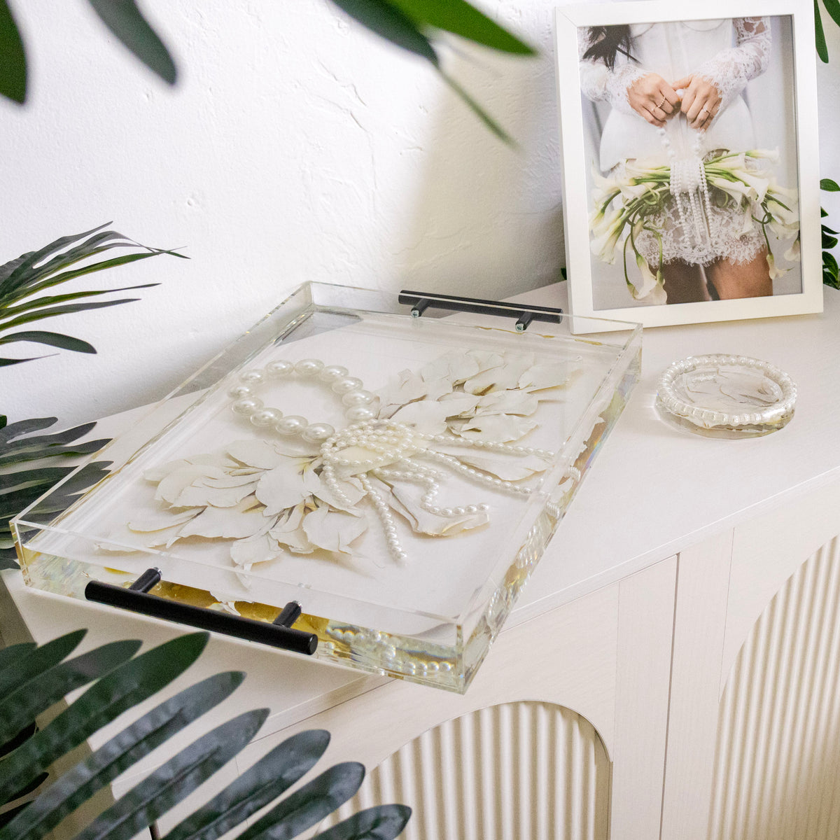 acrylic tray with encased calla lily purse bouquet preservation with pearls in resin and black handles.