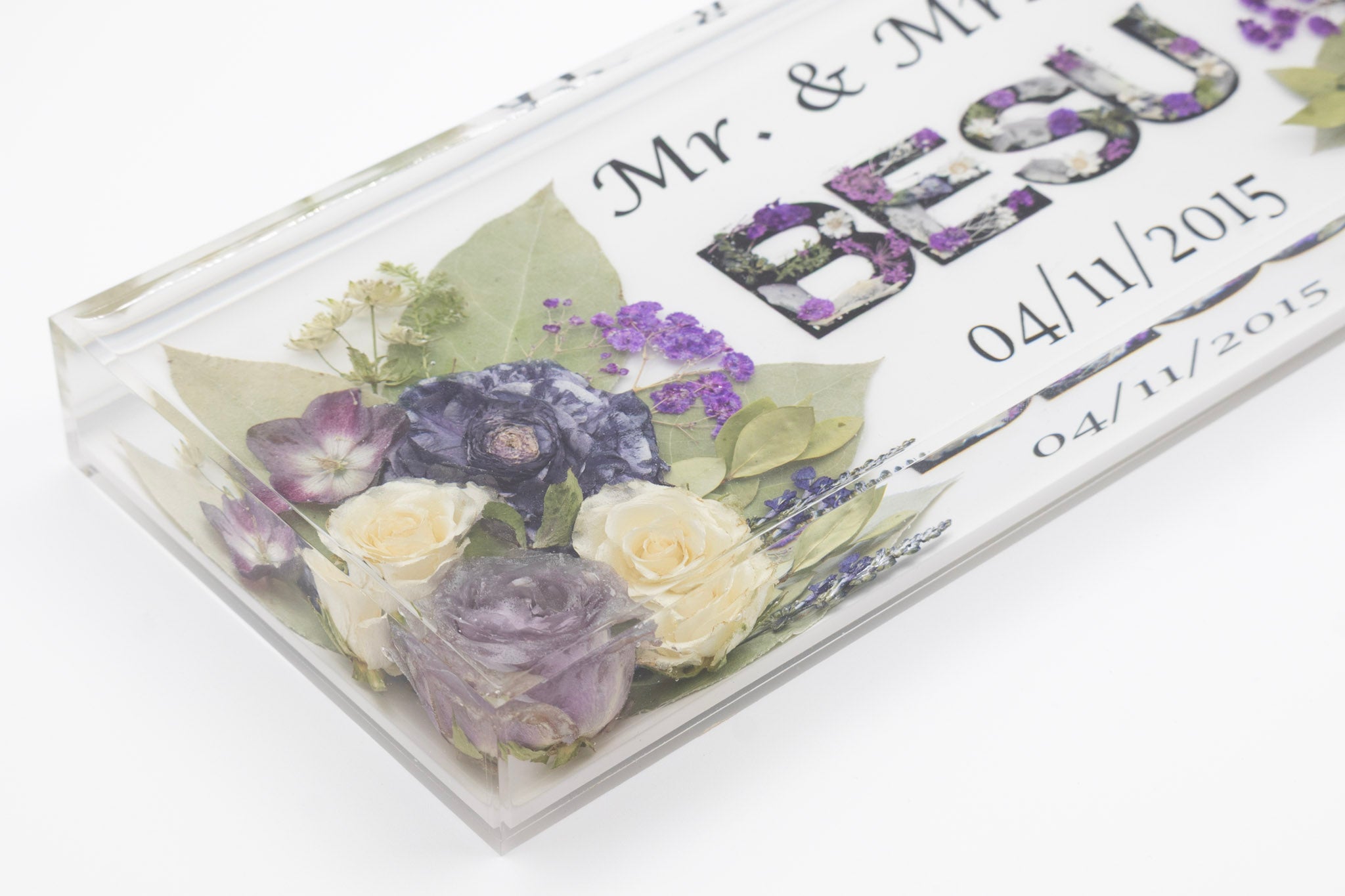 Close shot of wedding bouquet preservation rectangle block with floral resin letters and wedding date