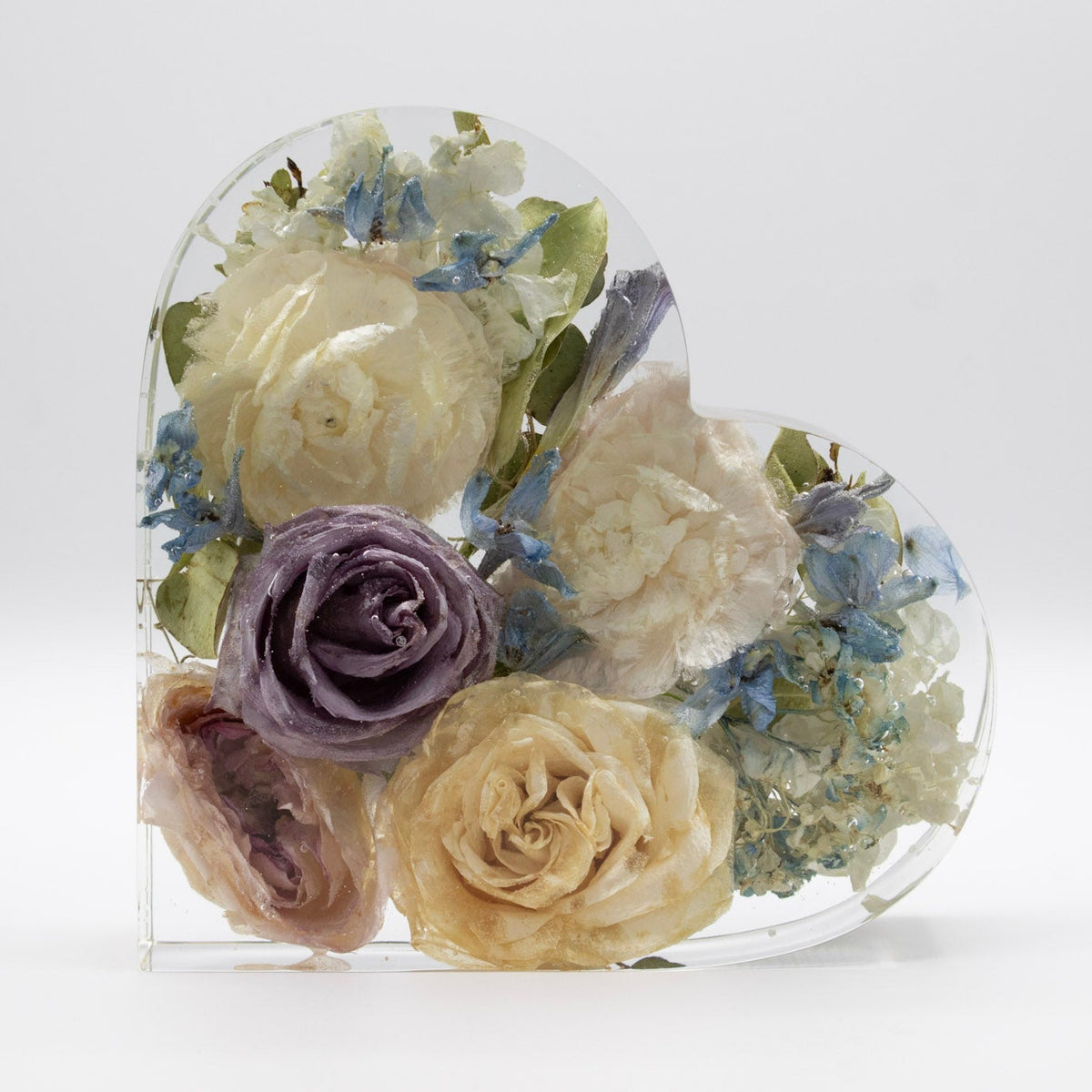 Resin Bouquet preservation of white ranunculus, blue delphinium and roses in epoxy encased heart block wedding keepsake display