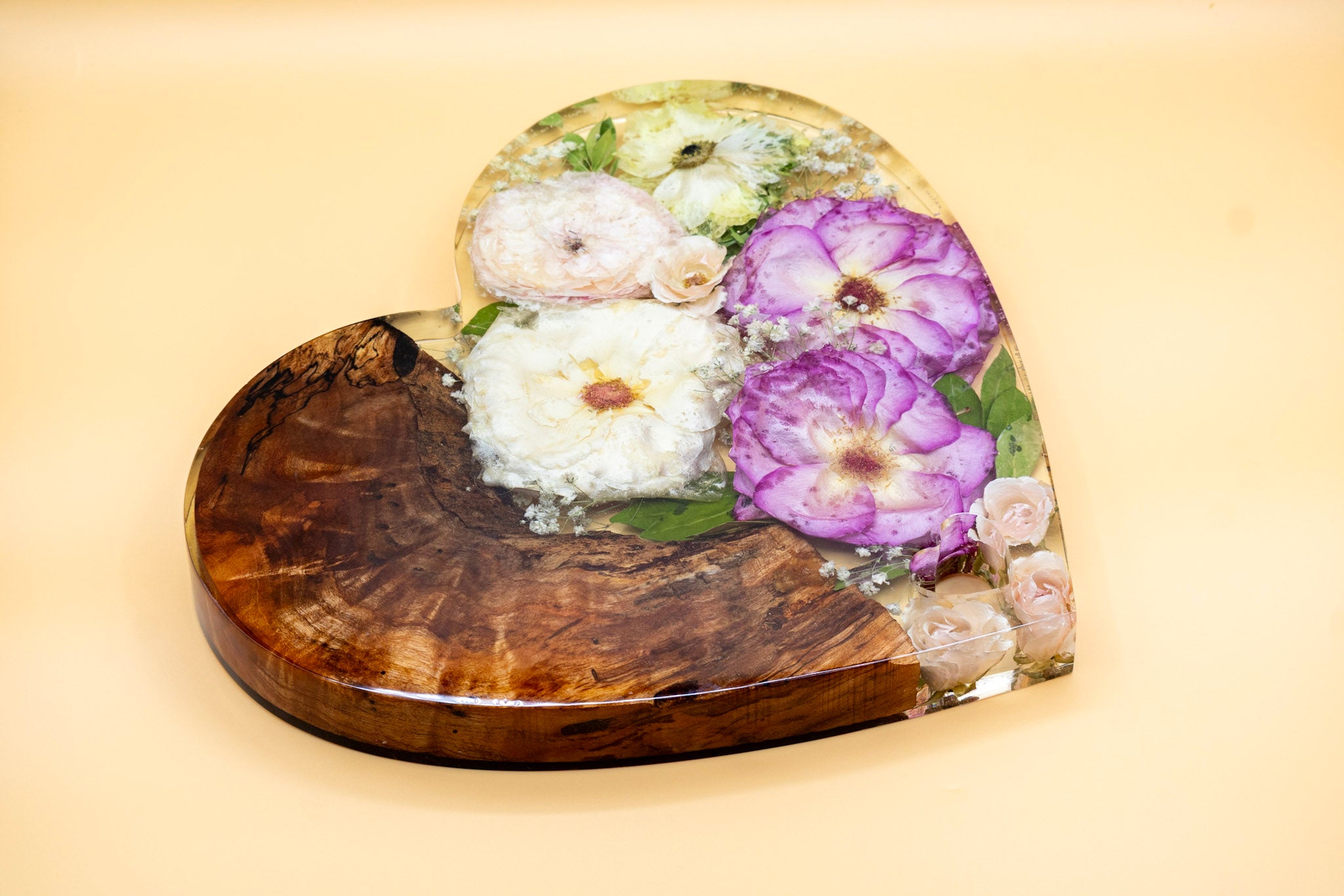 Standing Resin Heart Block with Live Edge Cedar and Preserved Pink and White Wedding Bouquet on a Tan Surface