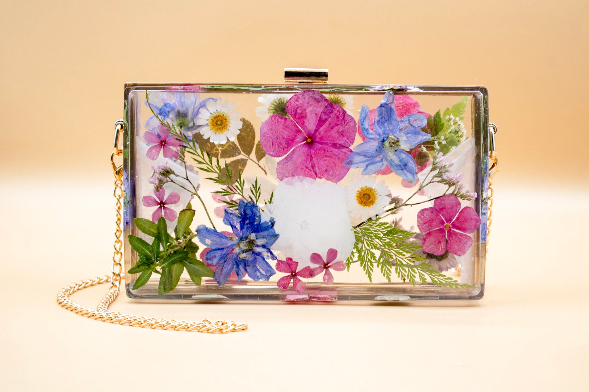 Resin Purse Pressed Flower Preservation Purser with Gold Hardware on beige background