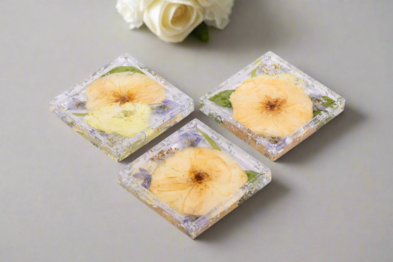 3 pressed flower square trinket trays with white and blue bouquet preservation and silver metallic flake.