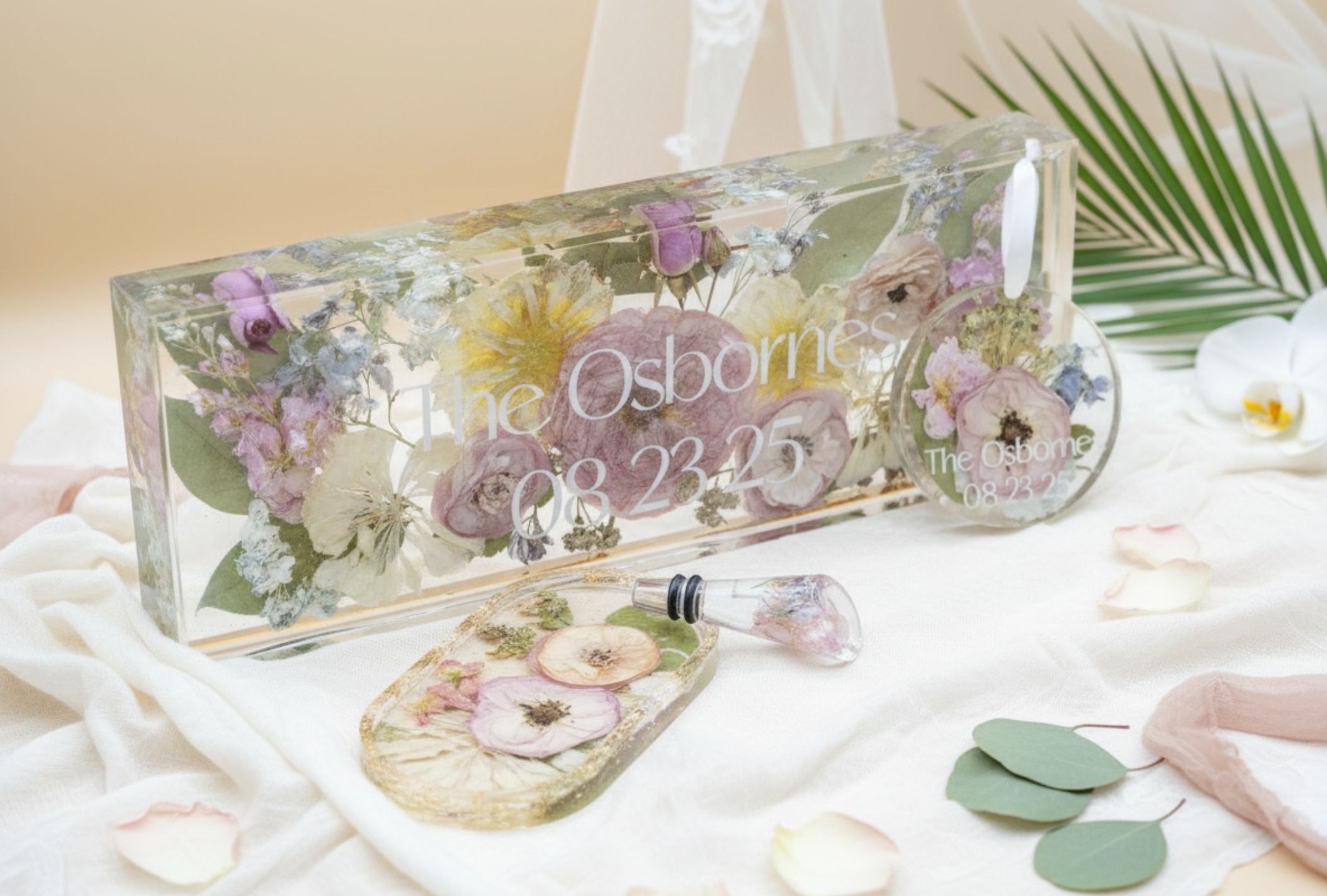 pressed flower banner with floral design and text on a soft surface.