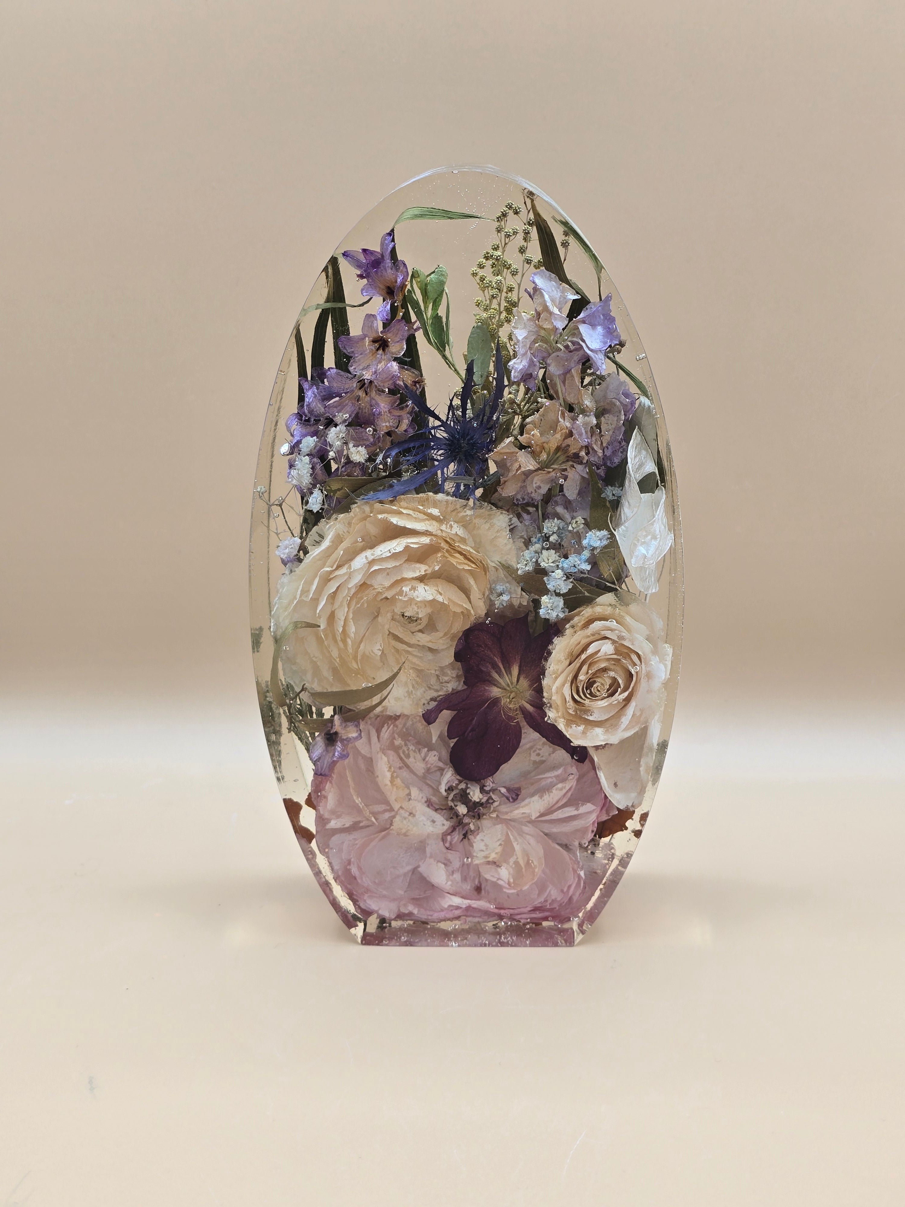 Premade 7-inch oval preserved flower bouquet block of roses, baby's breath and thistle in resin. Ready-to-ship floral keepsake and preserved flower gift for weddings, anniversaries, and memorials.